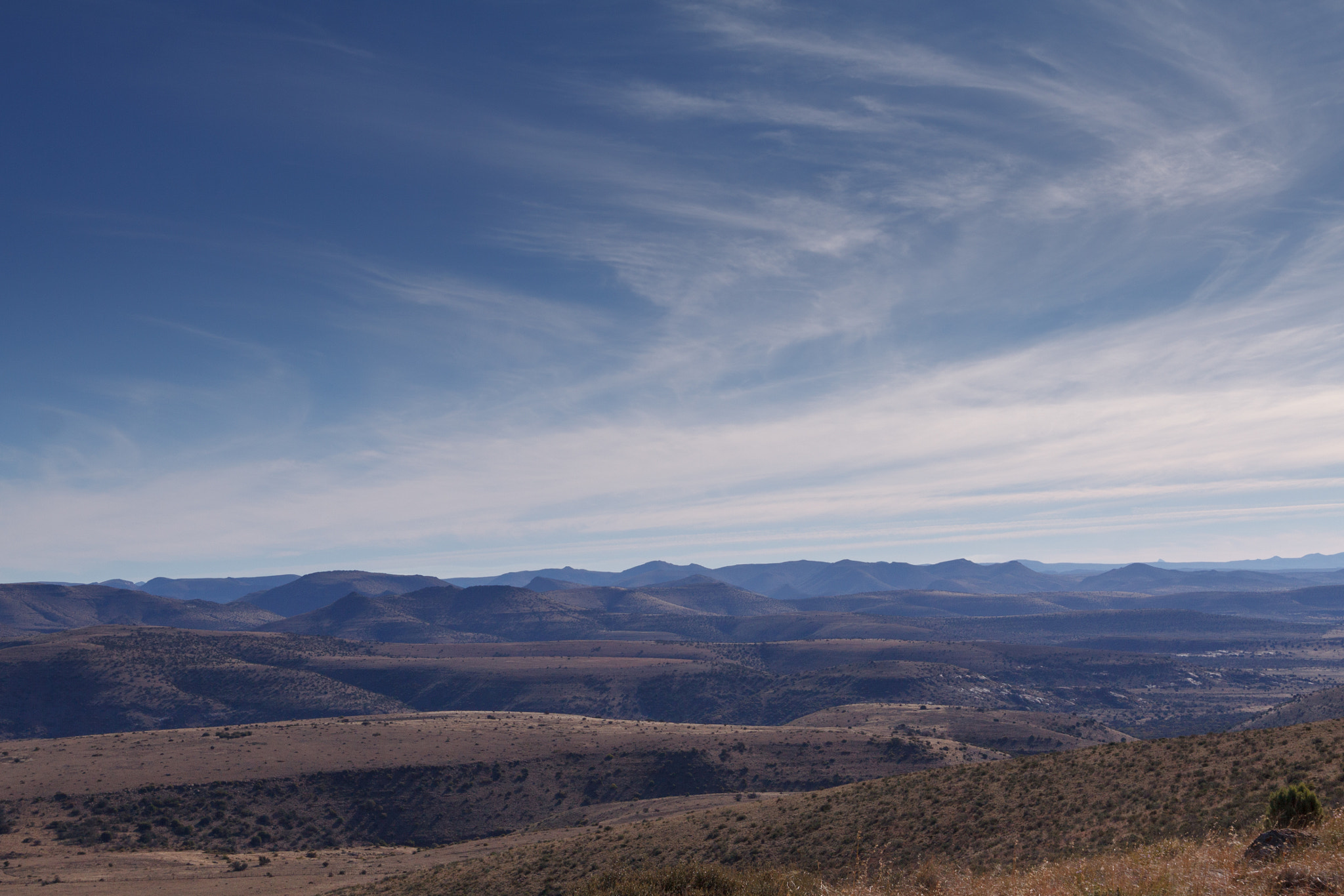 Canon EOS 50D + Canon EF 300mm f/2.8L sample photo. Fields of mountains with a storm in the clouds photography