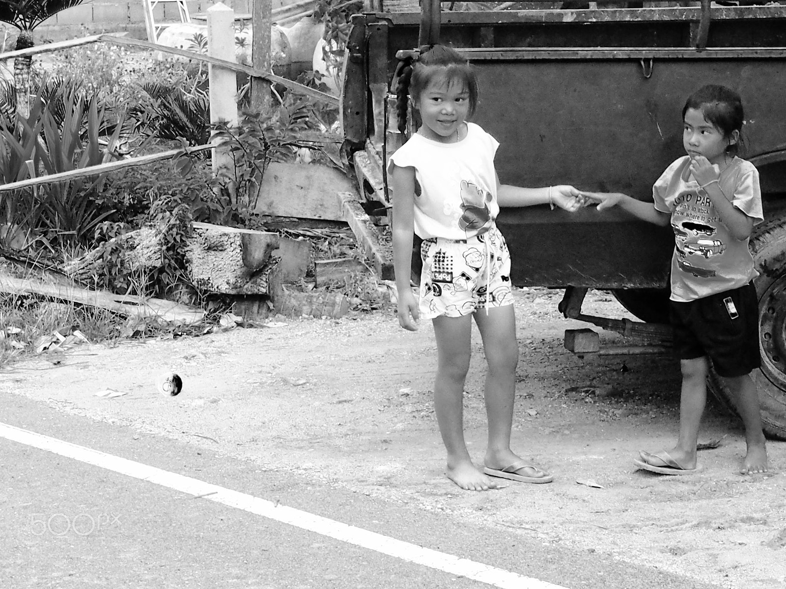 Olympus OM-D E-M5 + Panasonic Lumix G 20mm F1.7 ASPH sample photo. Two girls sharing one pair of shoes photography