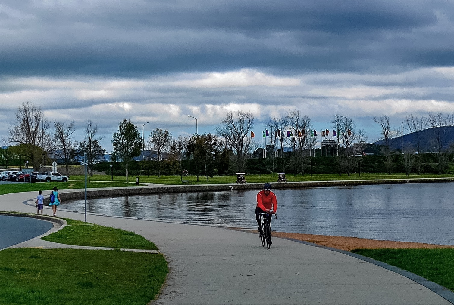 Panasonic DMC-GM1S sample photo. The biker - location:  the carillon, lake burley griffin, act, australia photography