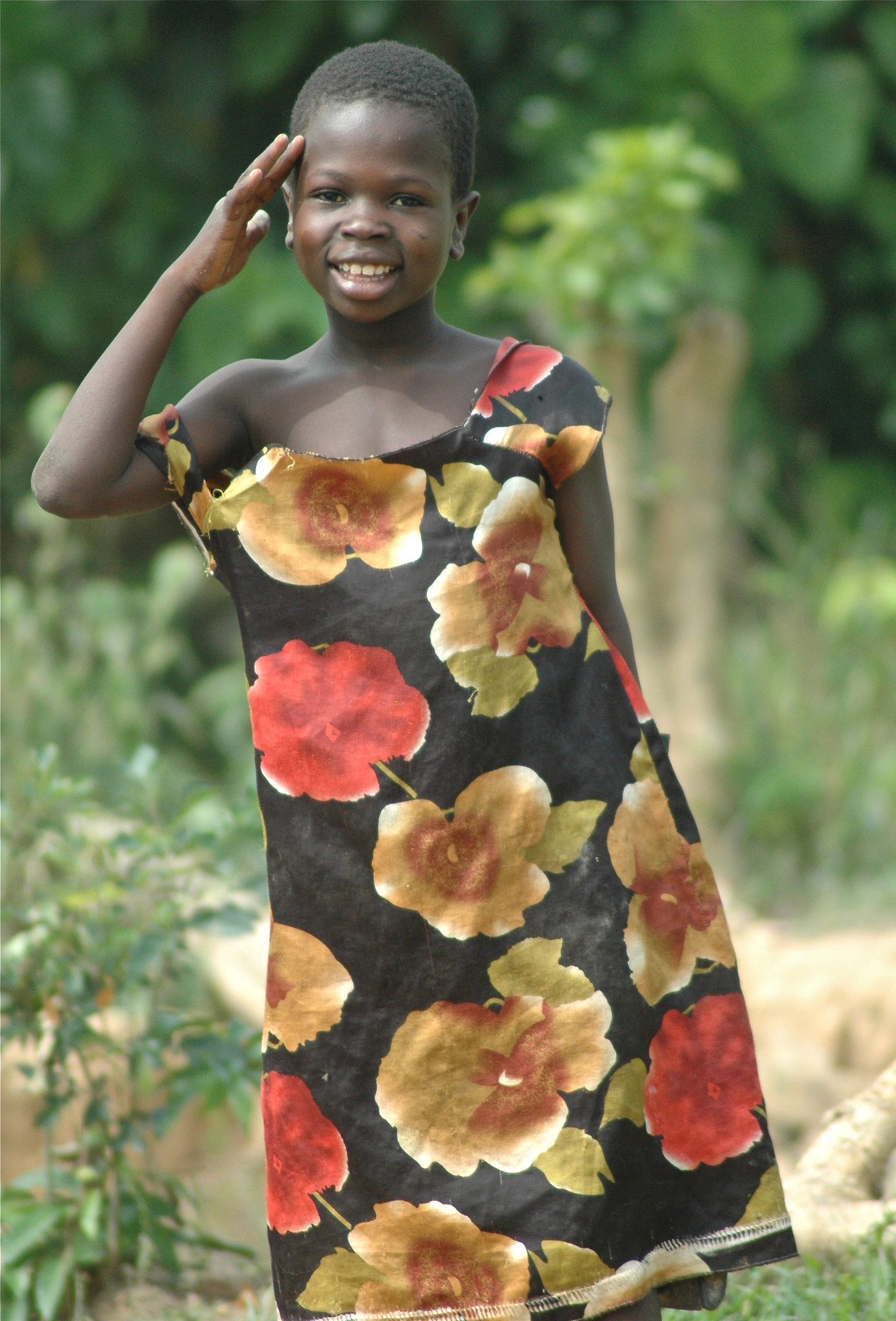 Nikon D70s + Tamron AF 70-300mm F4-5.6 Di LD Macro sample photo. Africa, west africa, ghana, village girl, child, flower dress, oversized dress, smiling, saluting photography