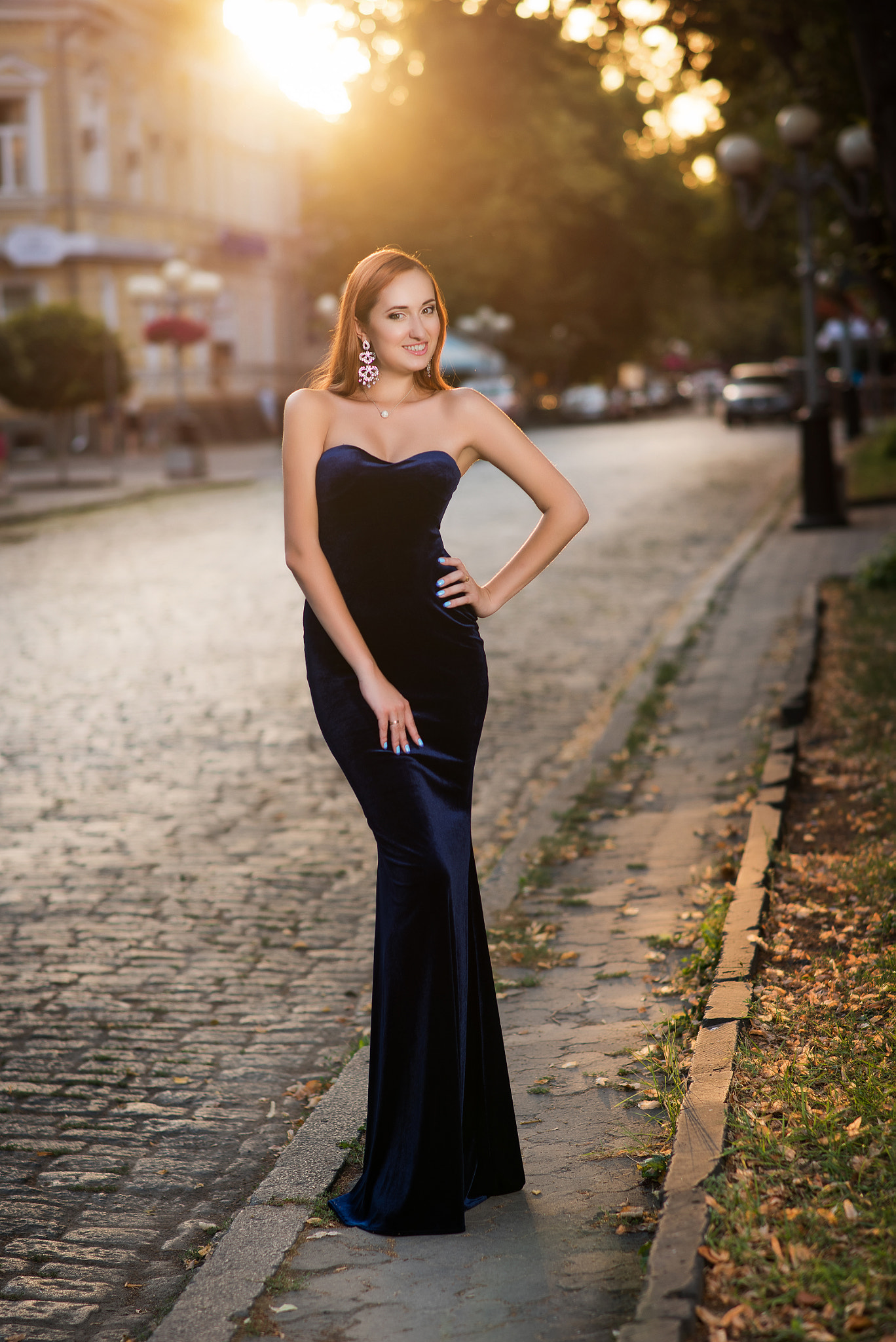 Nikon D810 + Sigma 85mm F1.4 EX DG HSM sample photo. A young beautiful slim woman in a long blue dress walking around the old town on a sunny summer day photography