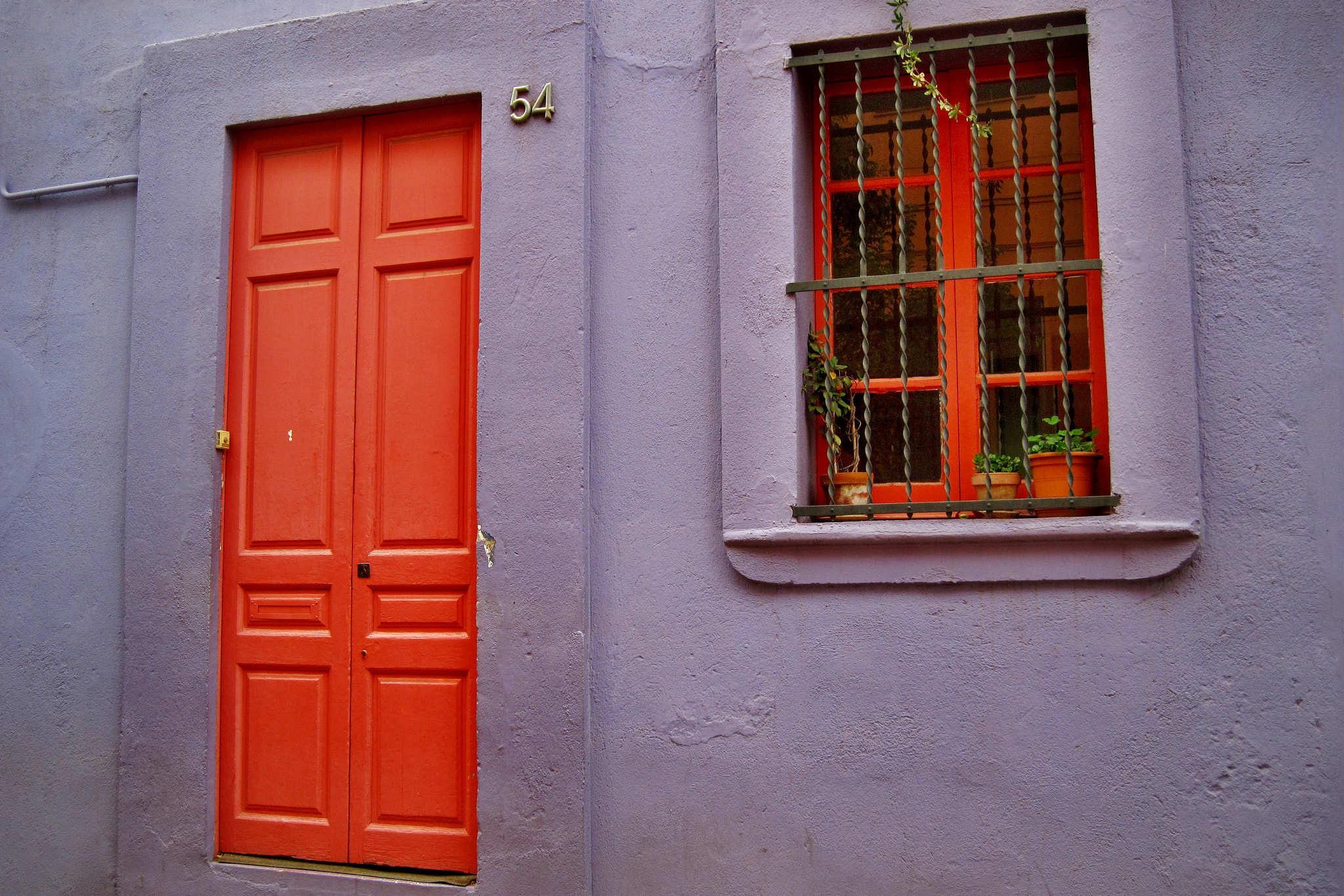 Canon PowerShot A1100 IS sample photo. Red window and door on the violet wall photography