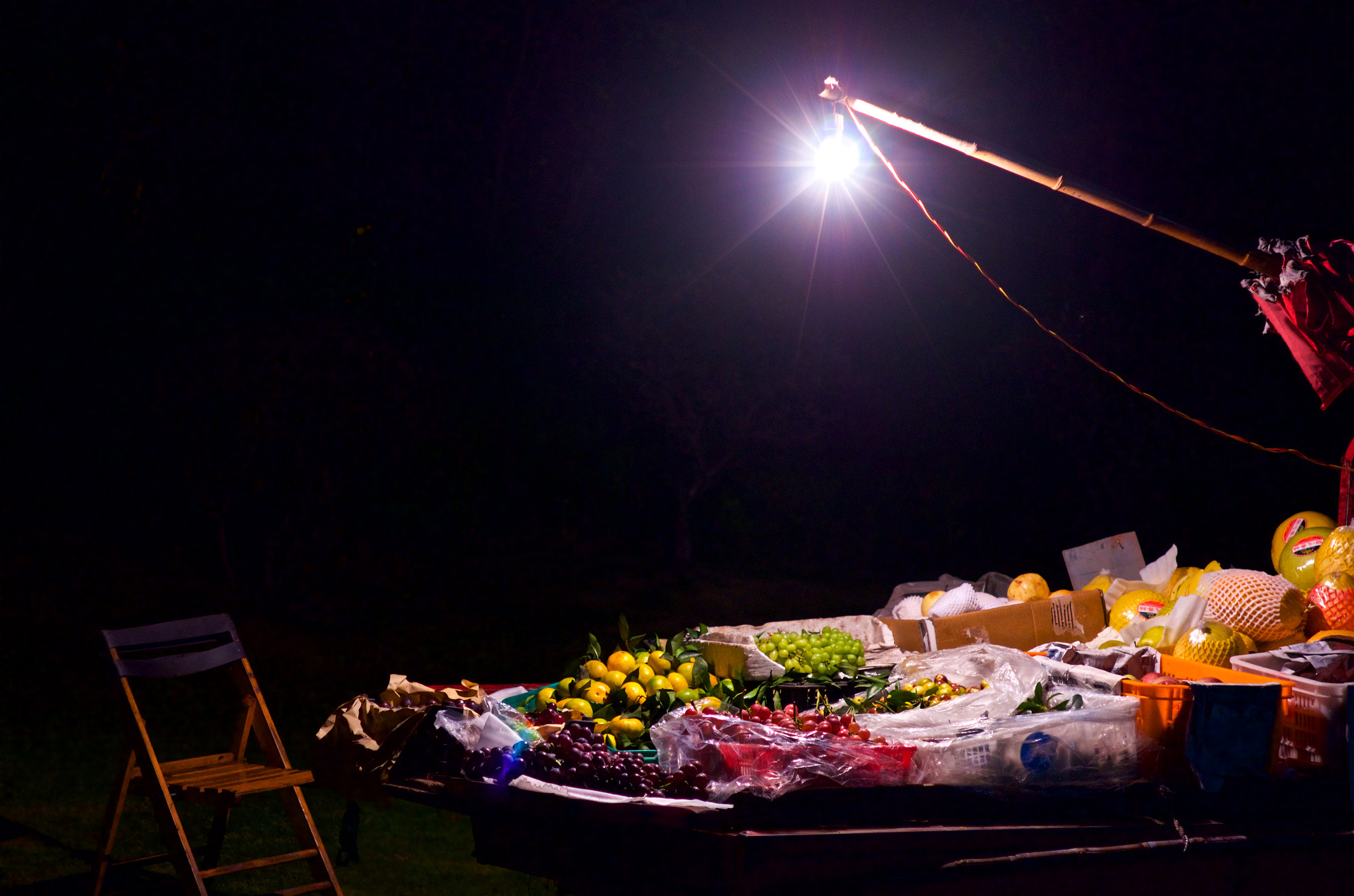 Pentax K-5 sample photo. Fruit stand on street in dark photography