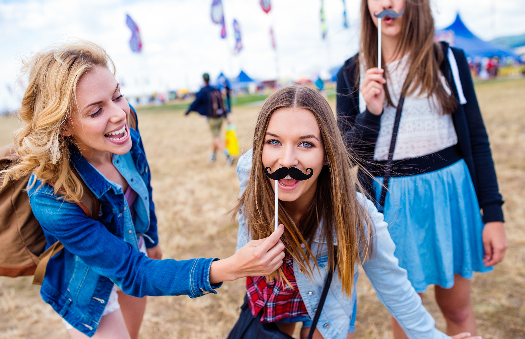 Nikon D4S + Sigma 35mm F1.4 DG HSM Art sample photo. Teenage girls at summer festival with fake mustache photography