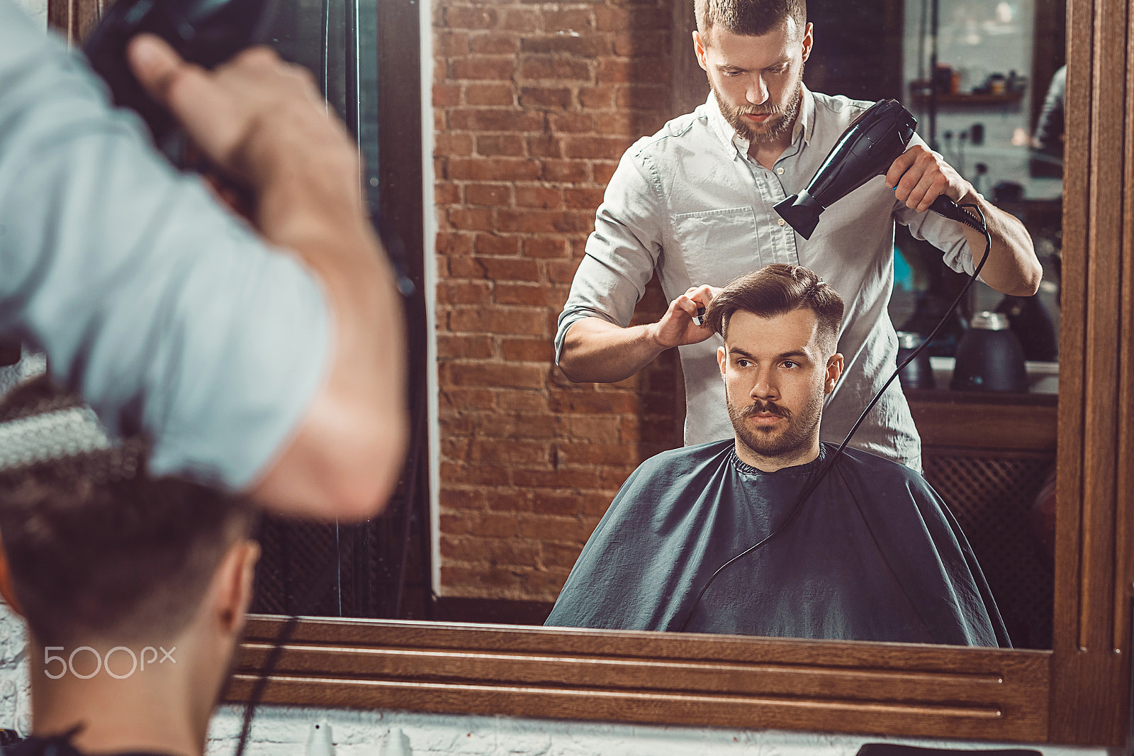 Canon EF 100mm F2.0 USM sample photo. Young handsome barber making haircut of attractive man in barbershop photography