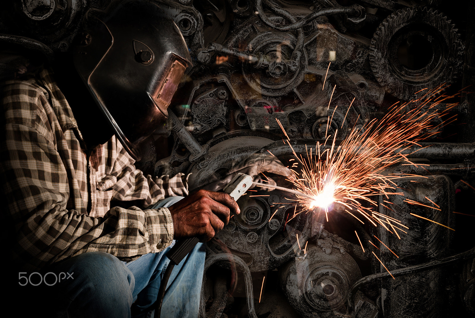 Sigma 17-70mm F2.8-4 DC Macro HSM | C sample photo. Welder at work with old machine steel background, industry conce photography