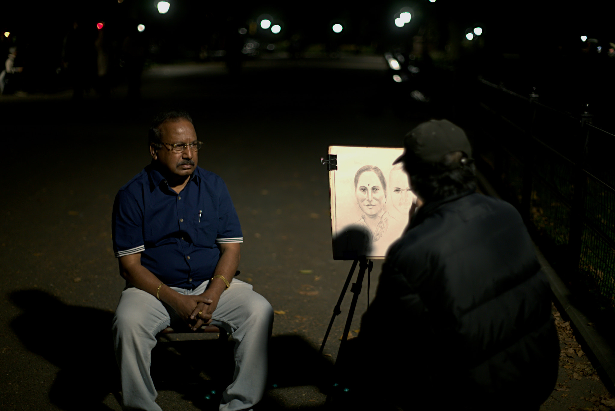 Sony a7 + Sony 50mm F1.4 sample photo. With only a street lamp as his guiding light, an artist continues to draw for his living. photography