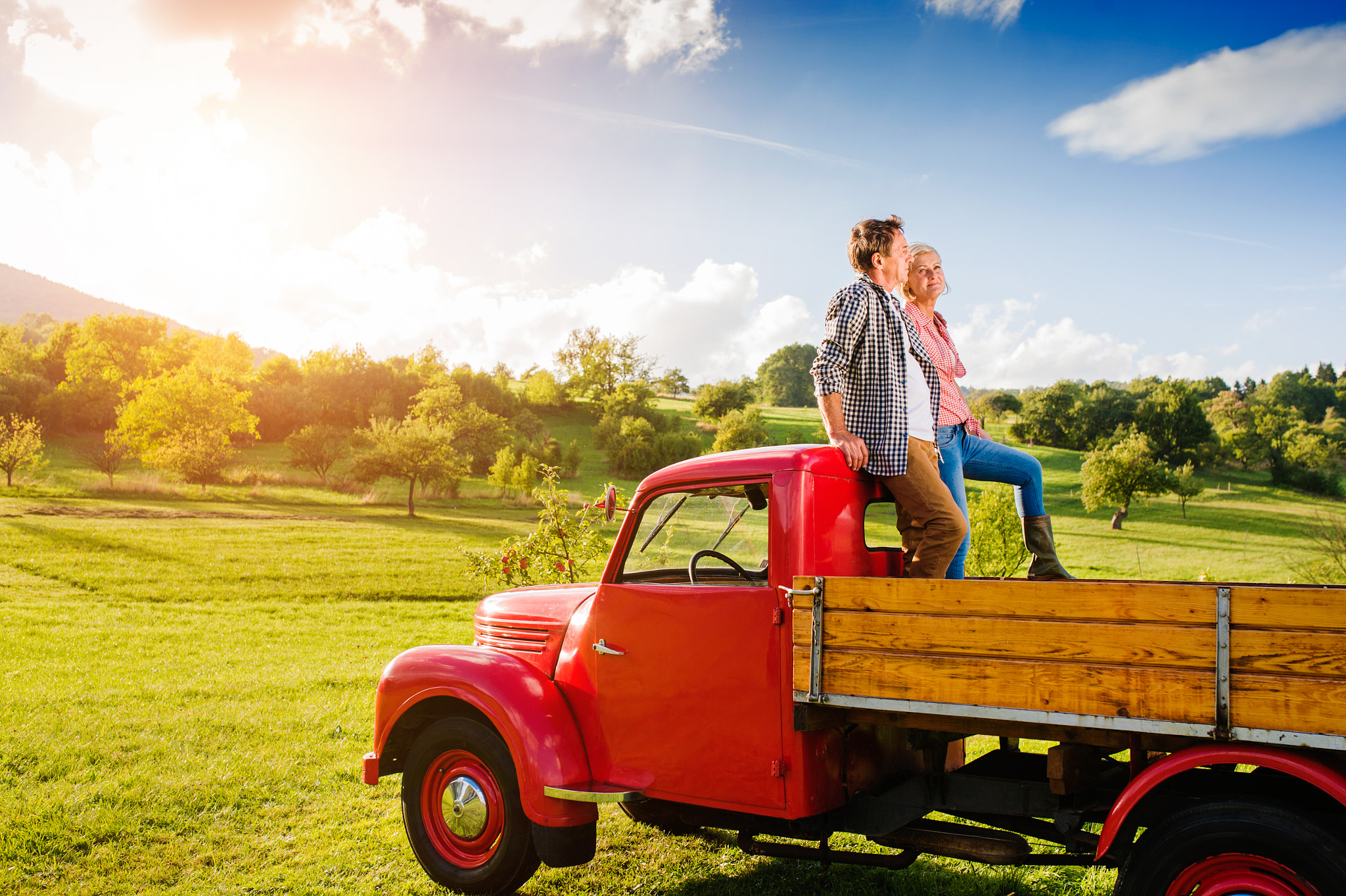 Nikon D4S + Sigma 35mm F1.4 DG HSM Art sample photo. Senior couple sitting in back of red pickup truck photography