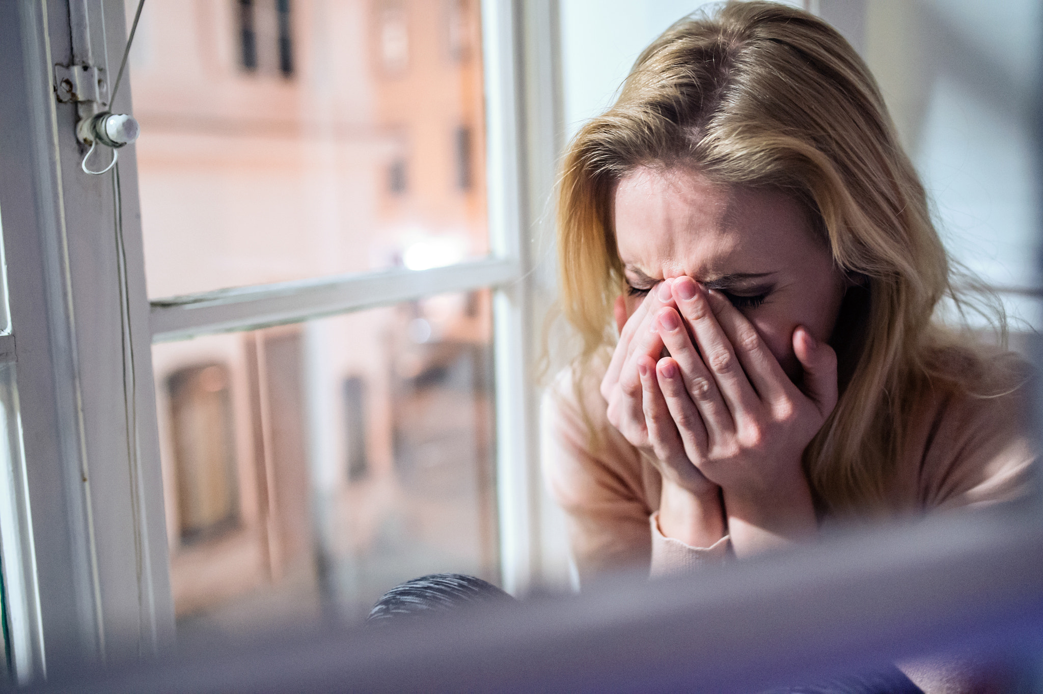 Nikon D4S + Sigma 35mm F1.4 DG HSM Art sample photo. Woman sitting on windowsill, looking out of window, crying photography