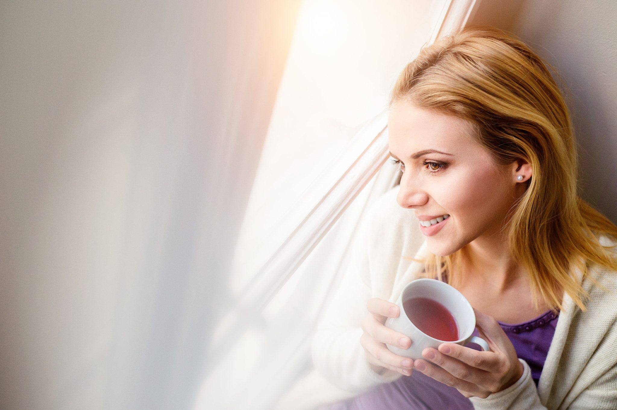 Nikon D4S sample photo. Woman on window sill holding a cup of tea photography