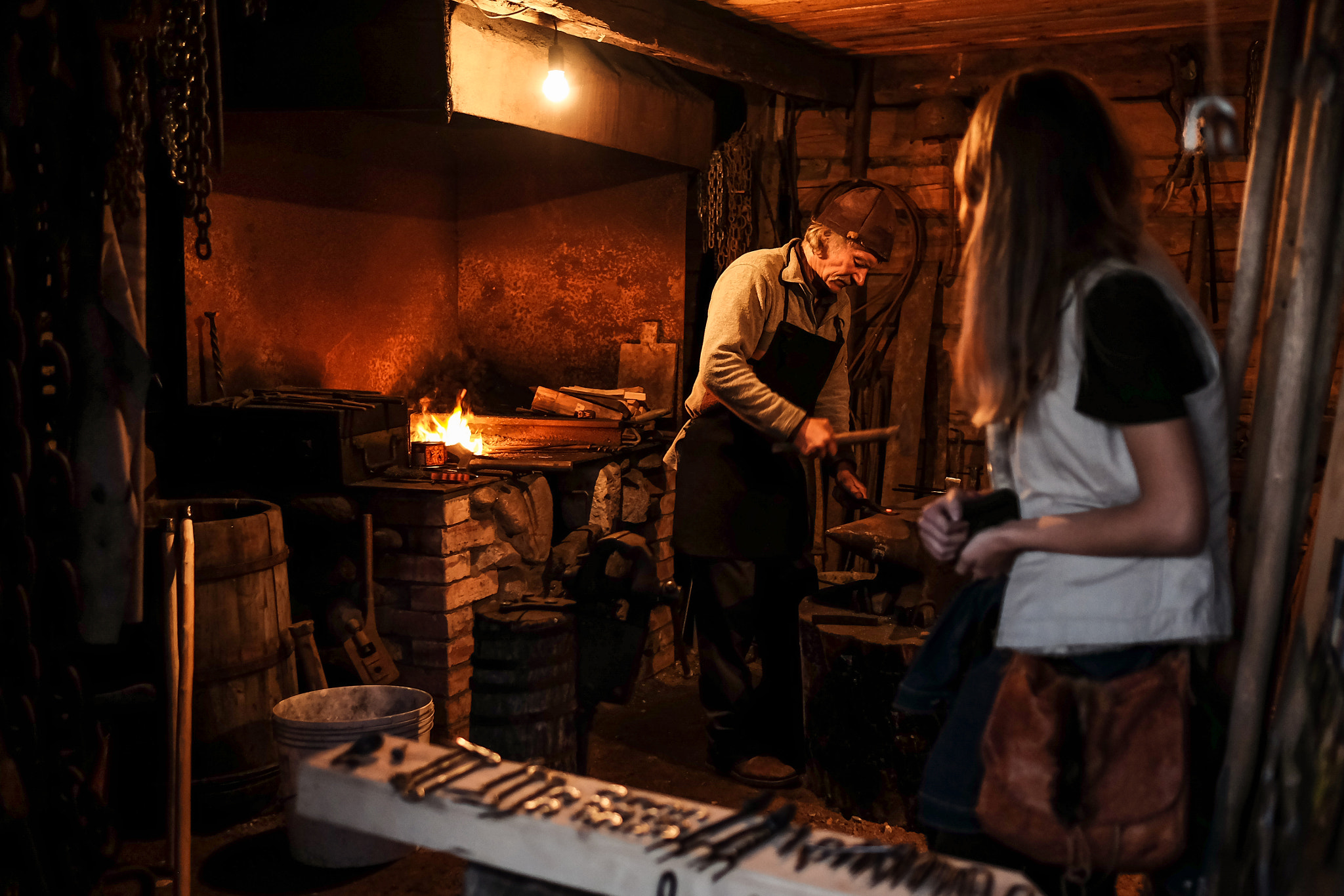 Fujifilm X-E2 + Fujifilm XF 23mm F1.4 R sample photo. Farrier at work in a forge photography