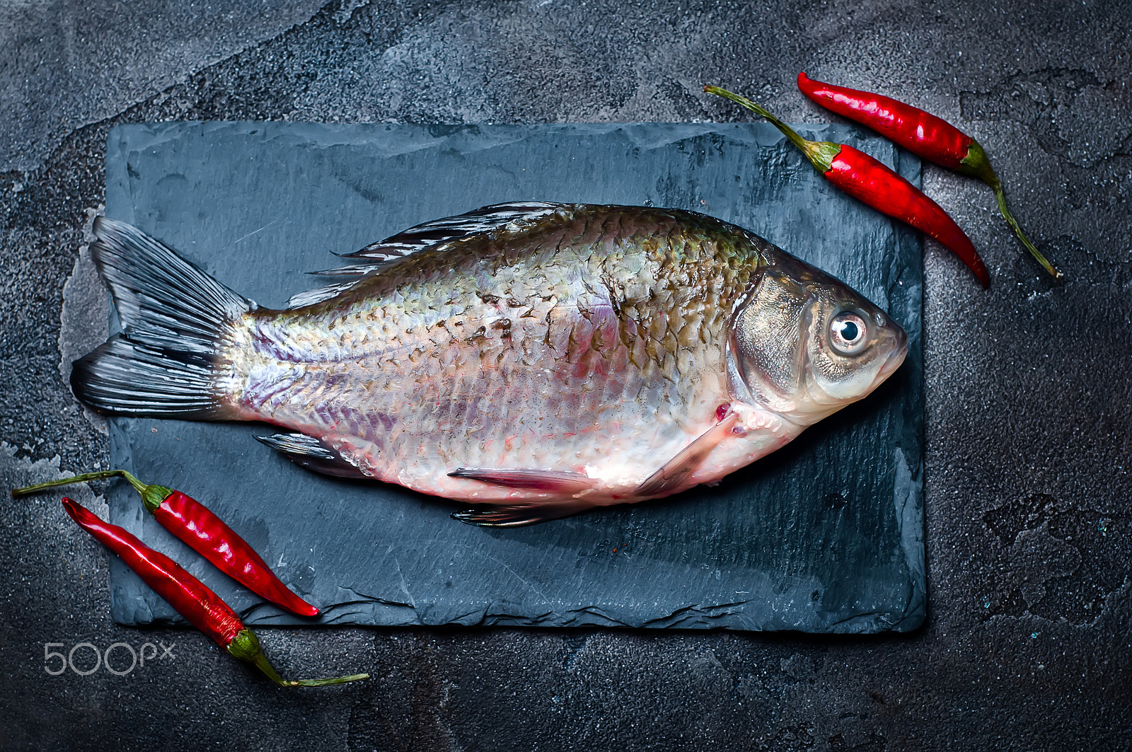 Nikon D90 + AF Nikkor 50mm f/1.8 sample photo. Fresh fish with spices on a stone board photography