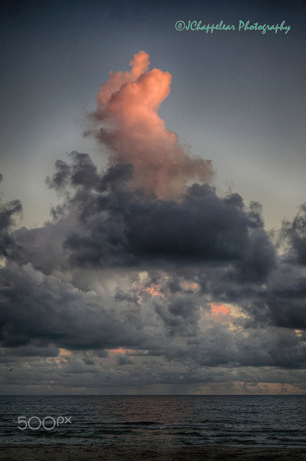 Sony Alpha NEX-5T + Sony E 55-210mm F4.5-6.3 OSS sample photo. Ocean sunset reflects off thunder head photography