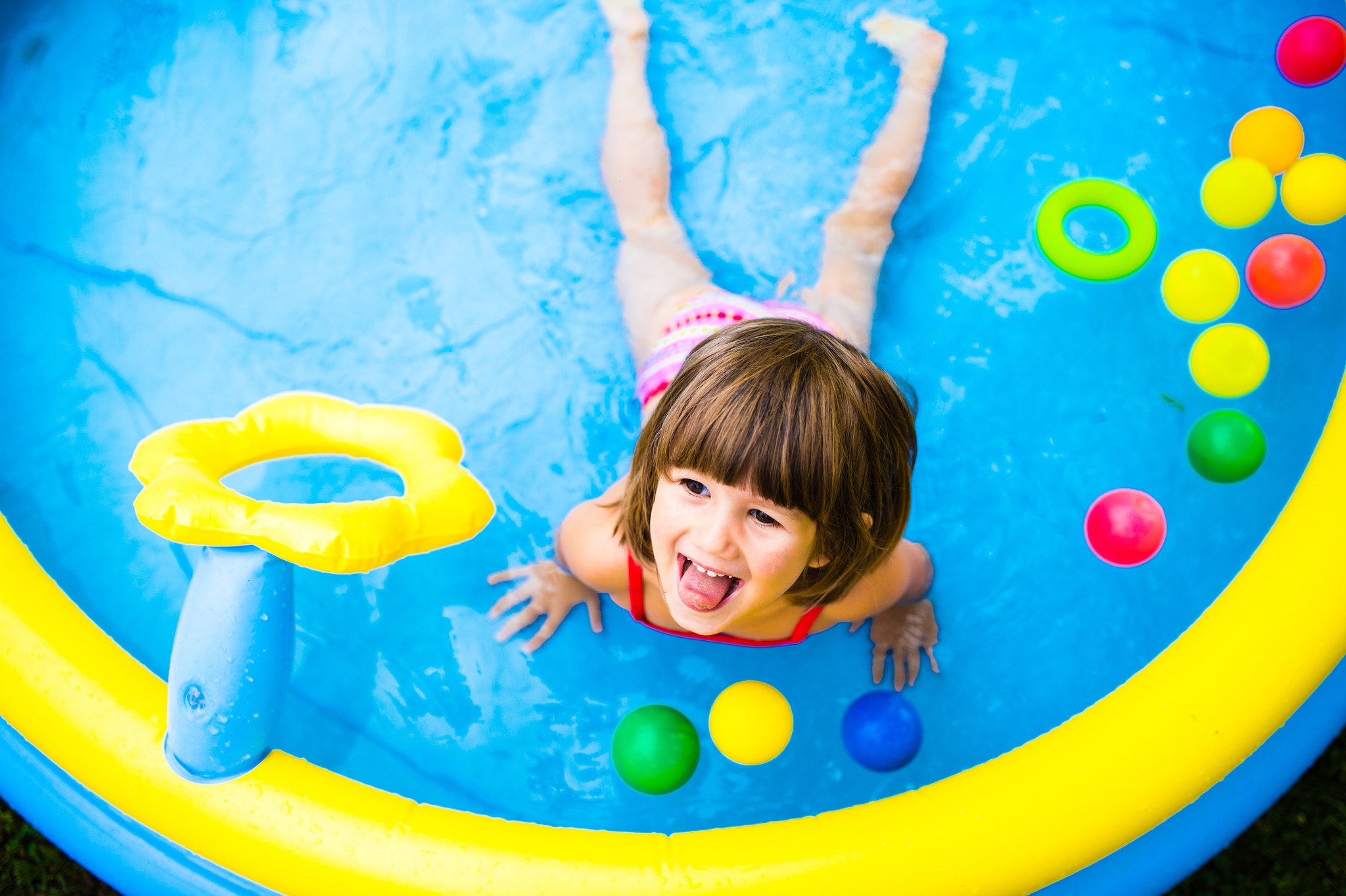 Nikon D4S + Sigma 35mm F1.4 DG HSM Art sample photo. Little girl having fun in the garden swimming pool. photography