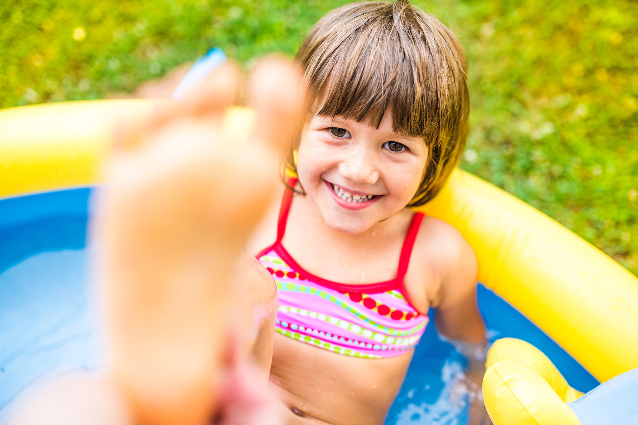 Nikon D4S + Sigma 35mm F1.4 DG HSM Art sample photo. Little girl having fun in the garden swimming pool. photography