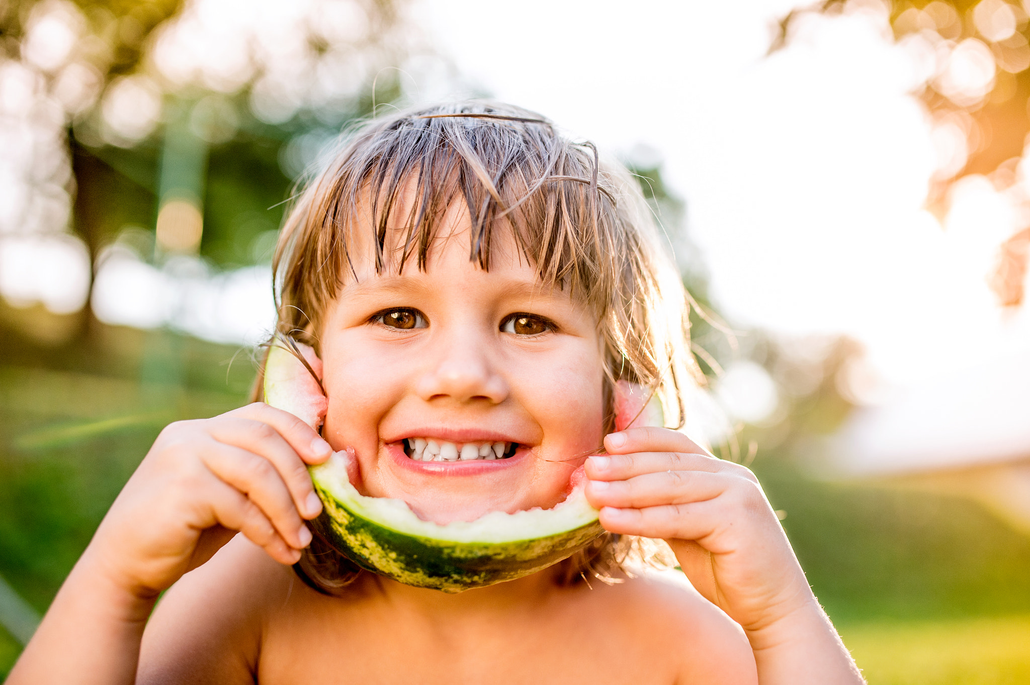 Nikon D4S + Sigma 35mm F1.4 DG HSM Art sample photo. Cute little girl eating watermelon in sunny summer garden photography