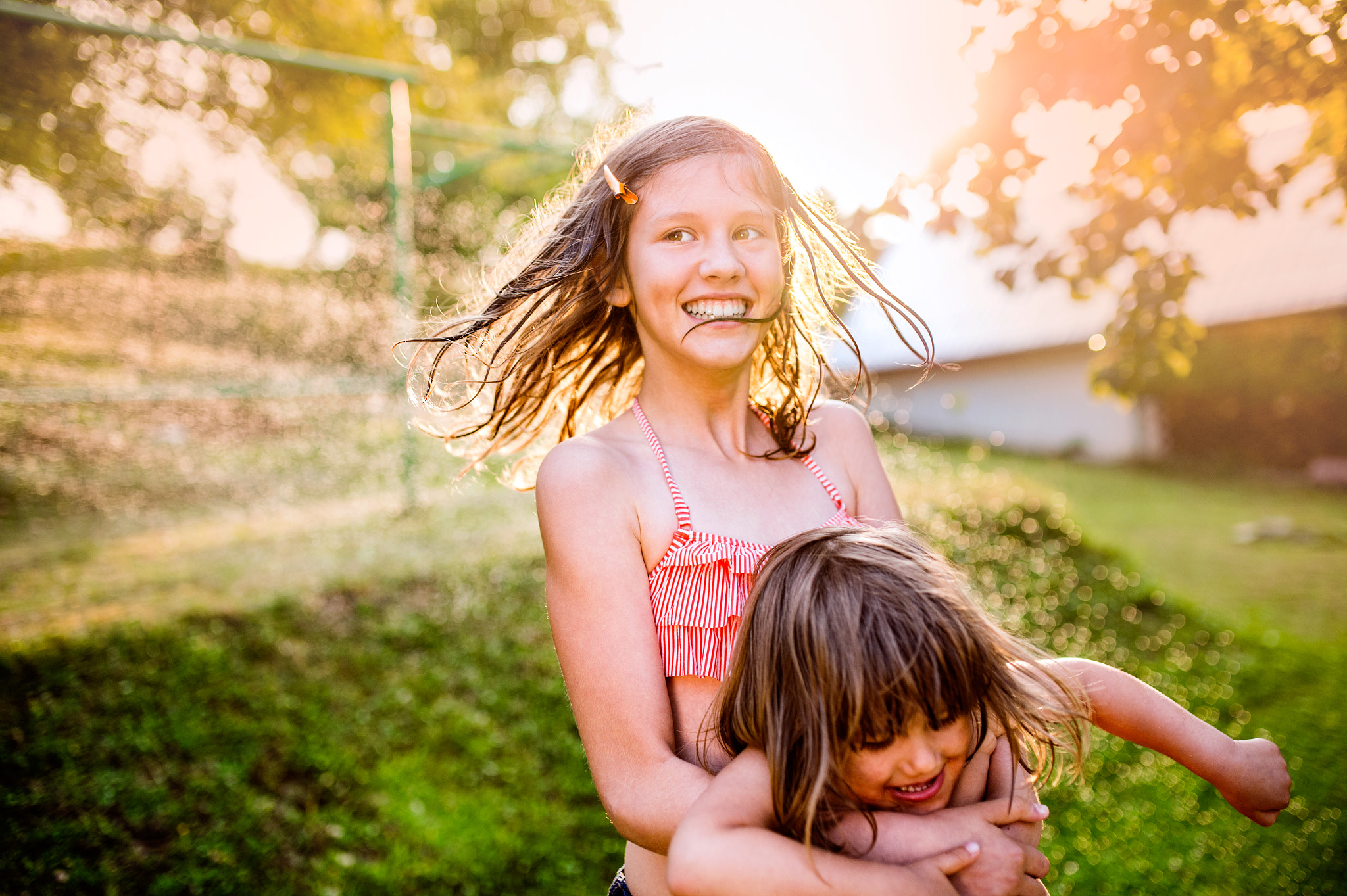 Nikon D4S + Sigma 35mm F1.4 DG HSM Art sample photo. Two cute girls having fun outside in summer garden photography