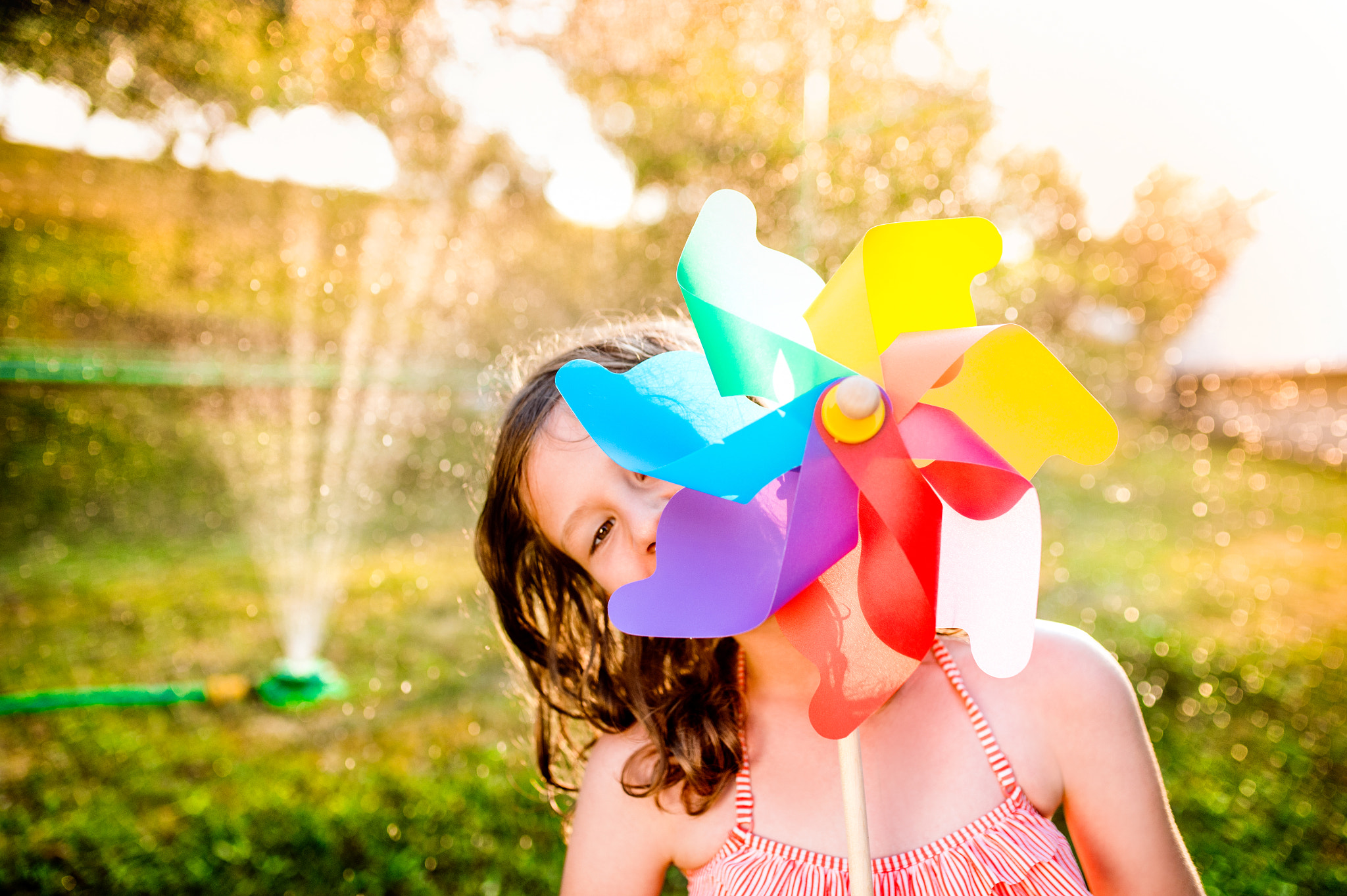 Nikon D4S + Sigma 35mm F1.4 DG HSM Art sample photo. Beautiful girl in swimsuit hiding behind pinwheel, summer garden photography