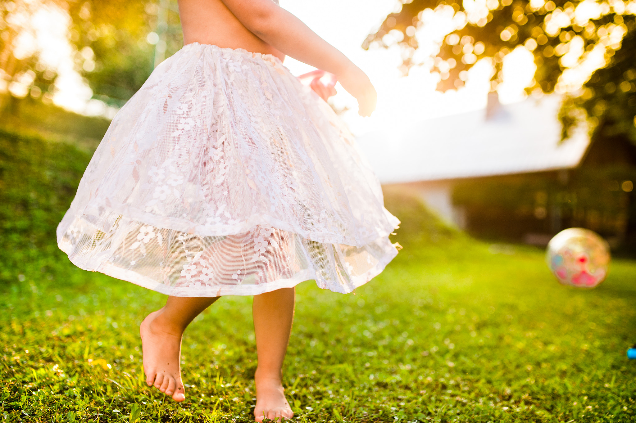 Nikon D4S + Sigma 35mm F1.4 DG HSM Art sample photo. Unrecognizable girl in princess skirt running in sunny garden photography