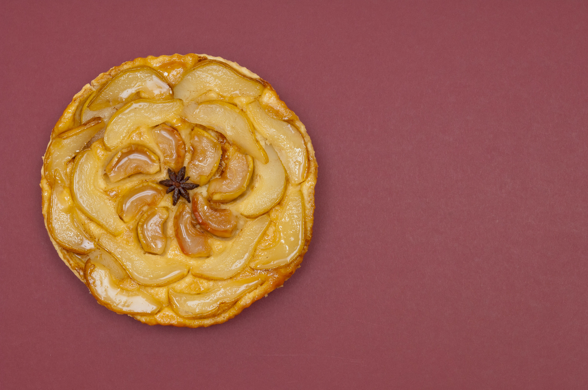 Nikon D2X sample photo. Whole tarte tatin apple pear tart isolated on claret background photography