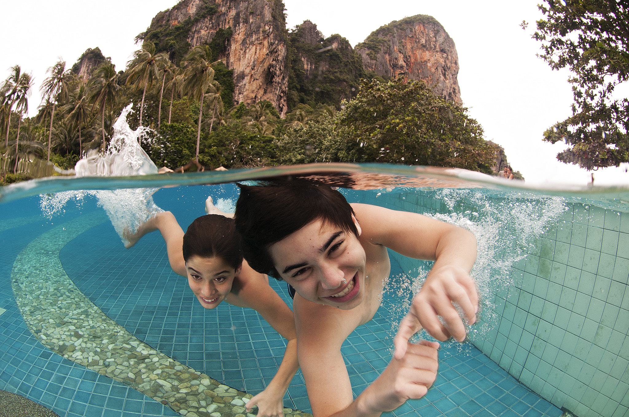 Nikon AF DX Fisheye-Nikkor 10.5mm F2.8G ED sample photo. Boys having fun underwater + karst mountains photography