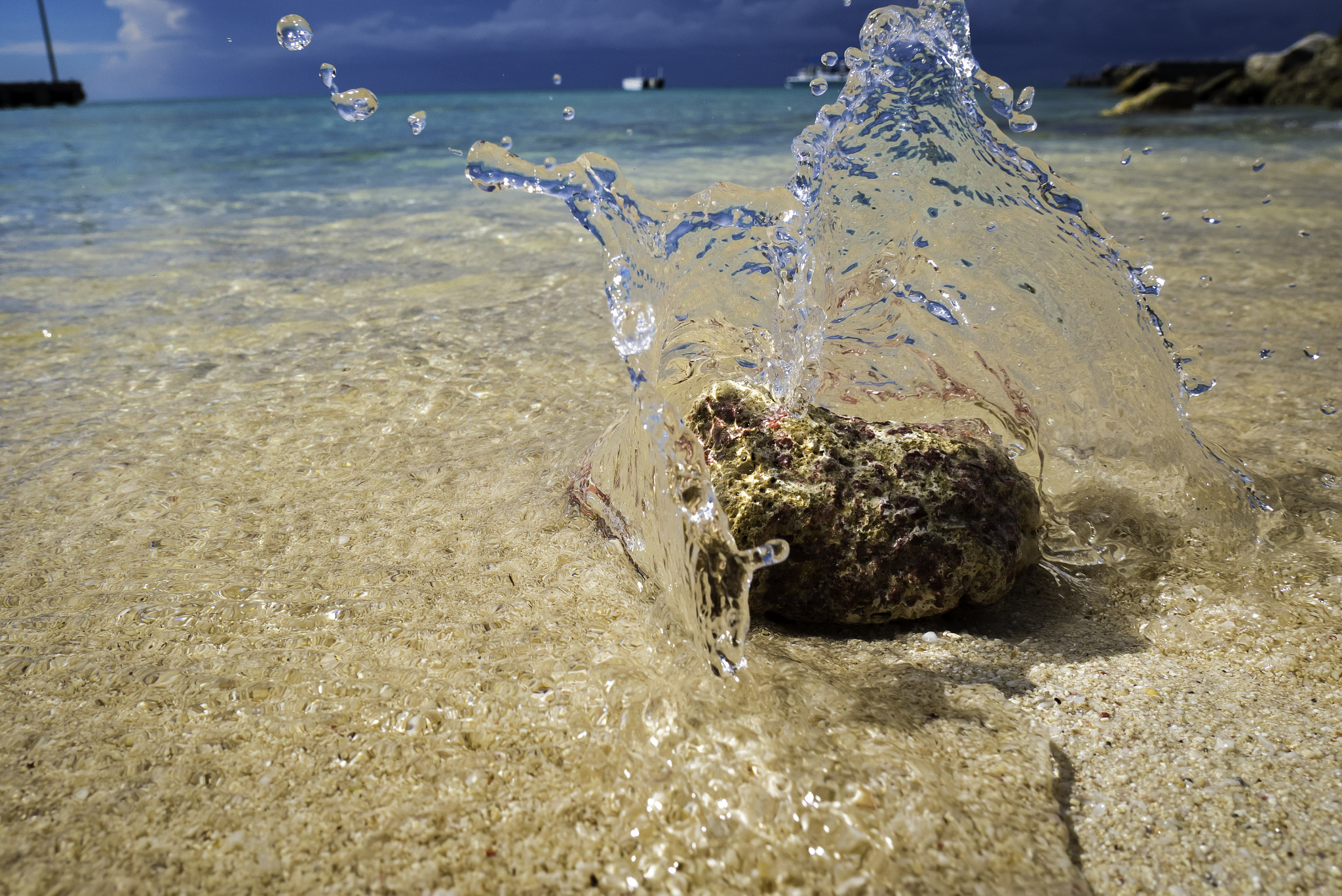 Panasonic Lumix DMC-GX85 (Lumix DMC-GX80 / Lumix DMC-GX7 Mark II) sample photo. The crystal clear waters cascade over the piece of coral on the beach in punta cana photography