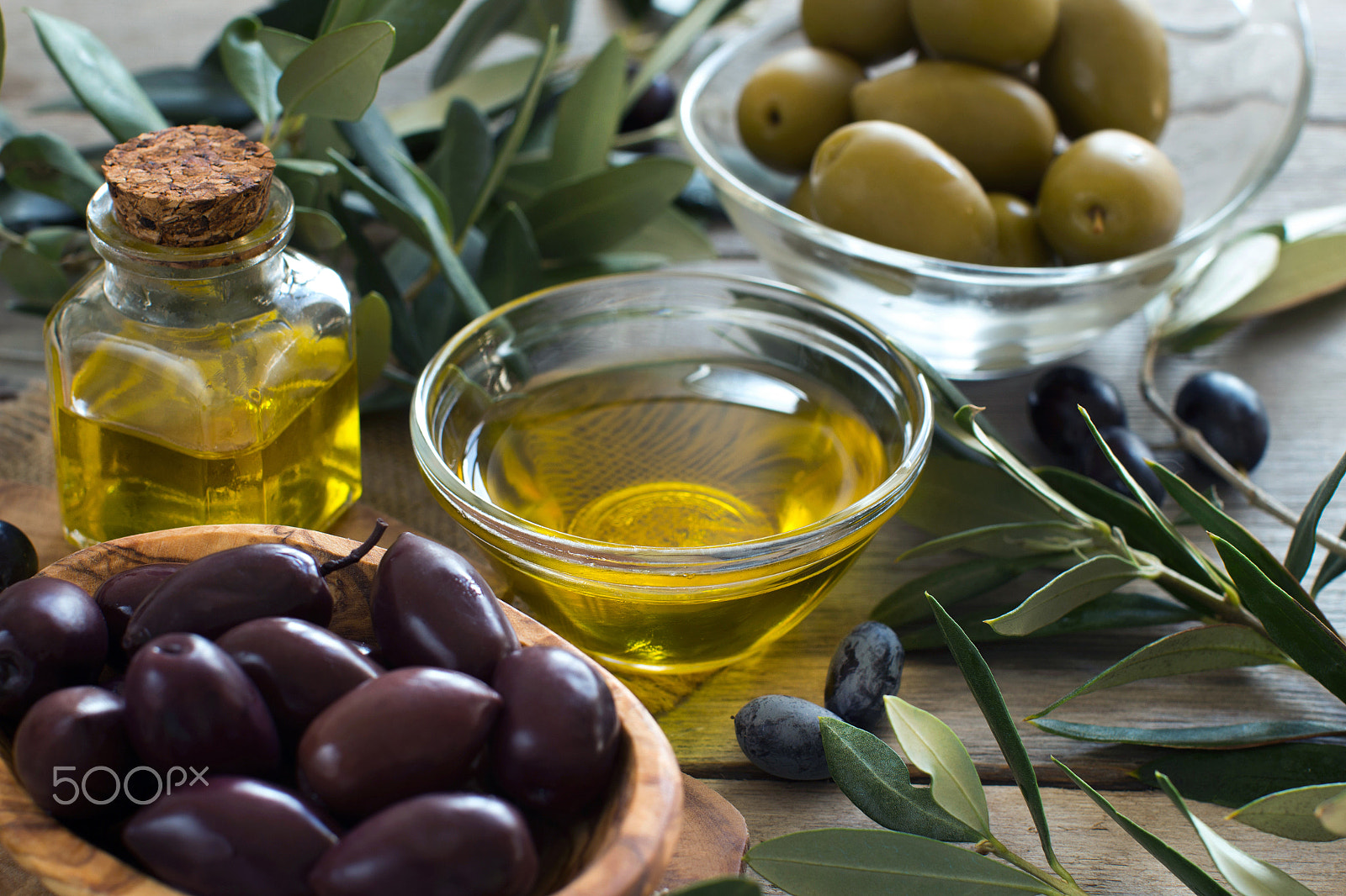 Canon EOS 650D (EOS Rebel T4i / EOS Kiss X6i) + Canon EF 50mm F1.2L USM sample photo. Olive oil and olives on wood background photography