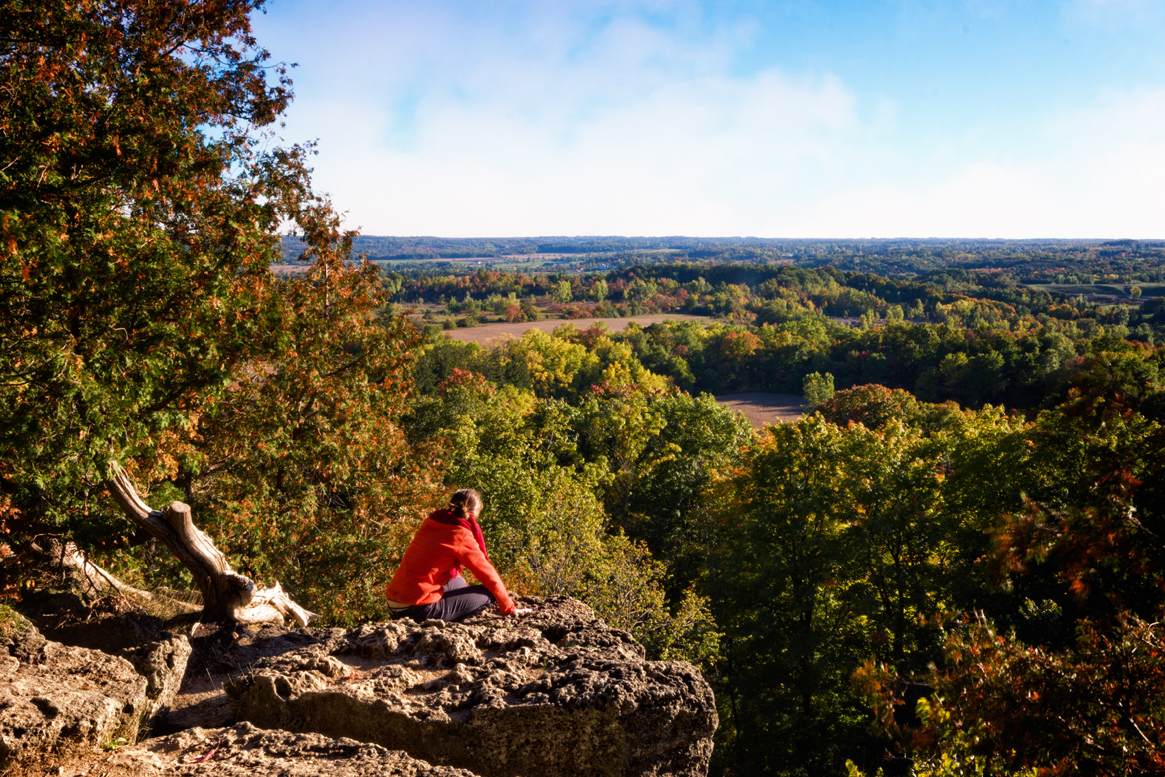 Sony a6000 + Sigma 10-20mm F4-5.6 EX DC HSM sample photo. A woman sitting on the edge of a rock photography