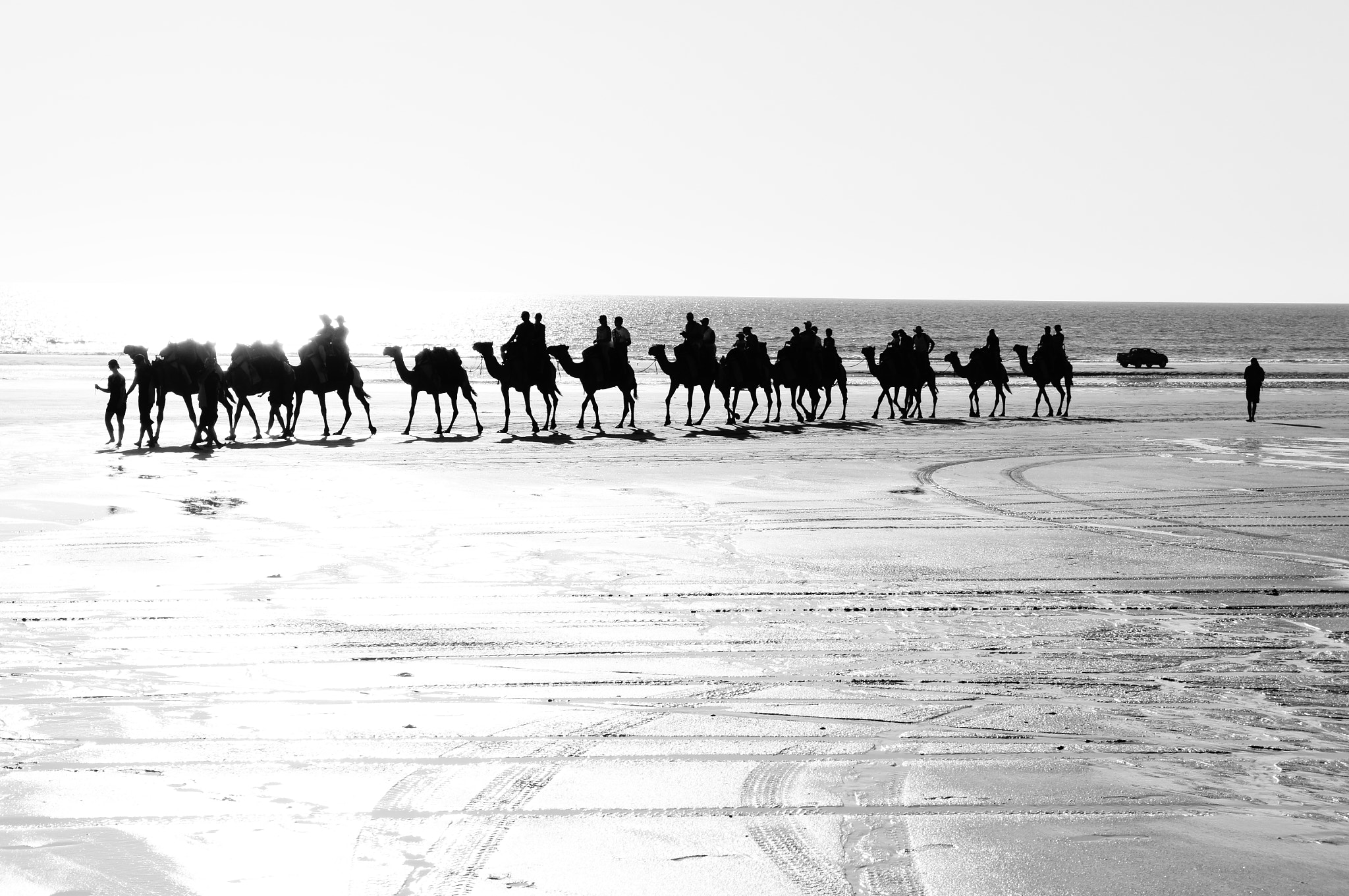 Sony Alpha NEX-C3 + Sony FE 28-70mm F3.5-5.6 OSS sample photo. Camels and a car on beach photography