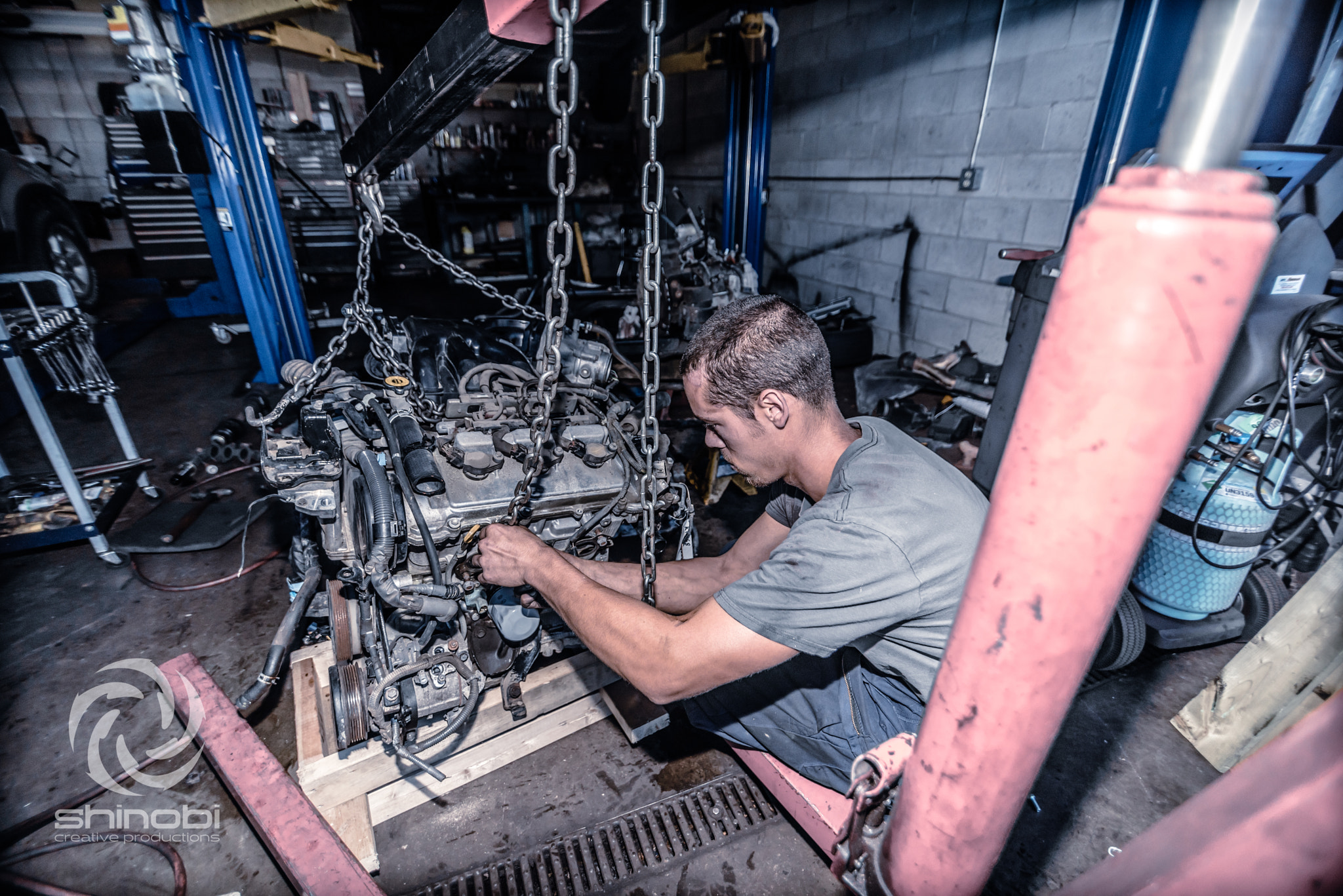 Tokina AT-X Pro 11-16mm F2.8 DX sample photo. Mechanic installing a car engine photography