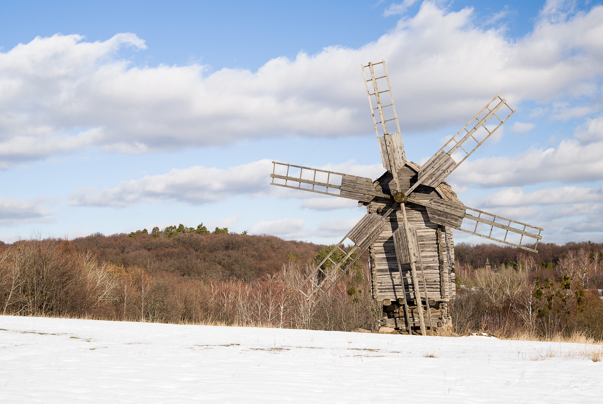 Nikon D800 sample photo. Windmill against a blue sky with clouds in winter photography