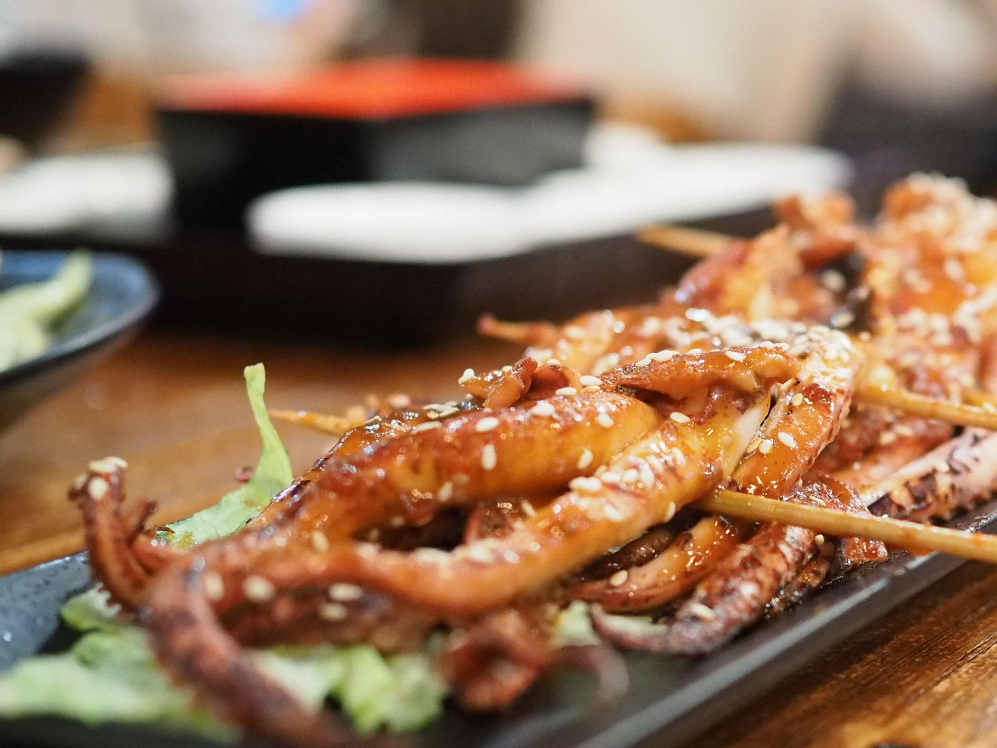 Olympus OM-D E-M5 II + Olympus M.Zuiko Digital 25mm F1.8 sample photo. Squid tentacle skewers - fantastic photography
