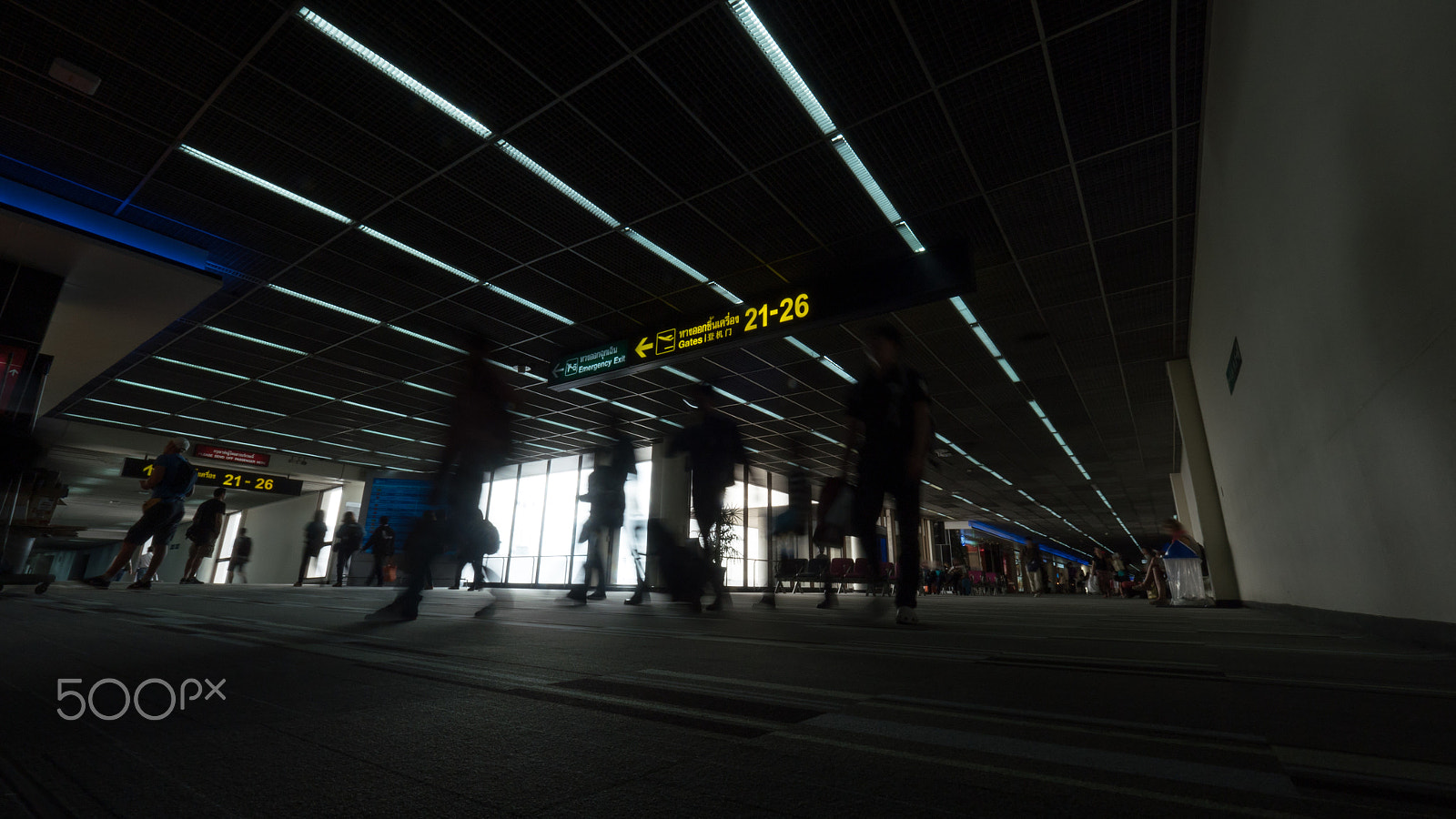 Panasonic Lumix DMC-GH4 + Olympus M.Zuiko Digital ED 7-14mm F2.8 PRO sample photo. People traffic in the airport terminal photography