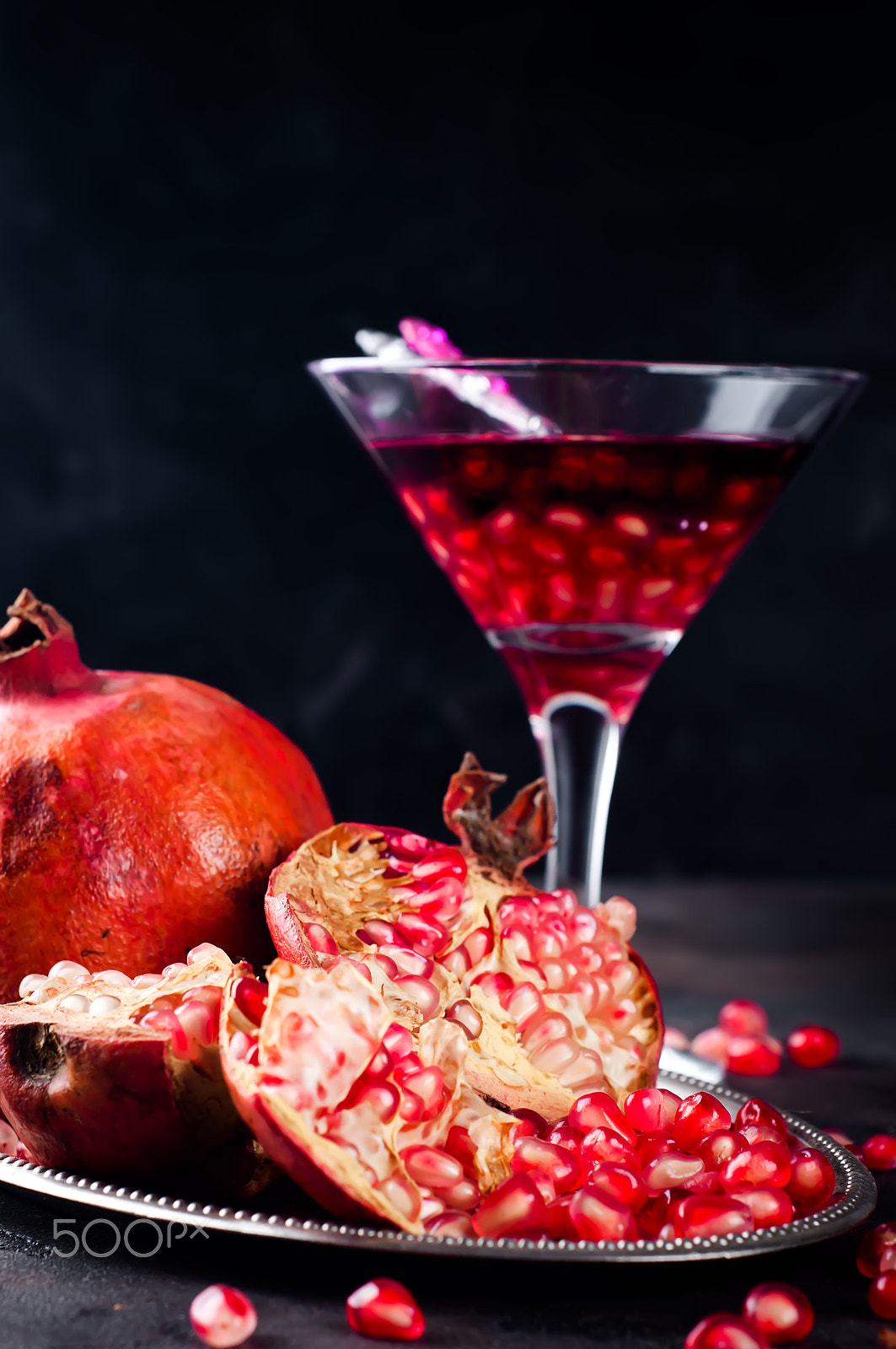 Nikon D90 + AF Nikkor 50mm f/1.8 sample photo. Pomegranate, cut into sections on a metal dish in the background of the shot glasses photography