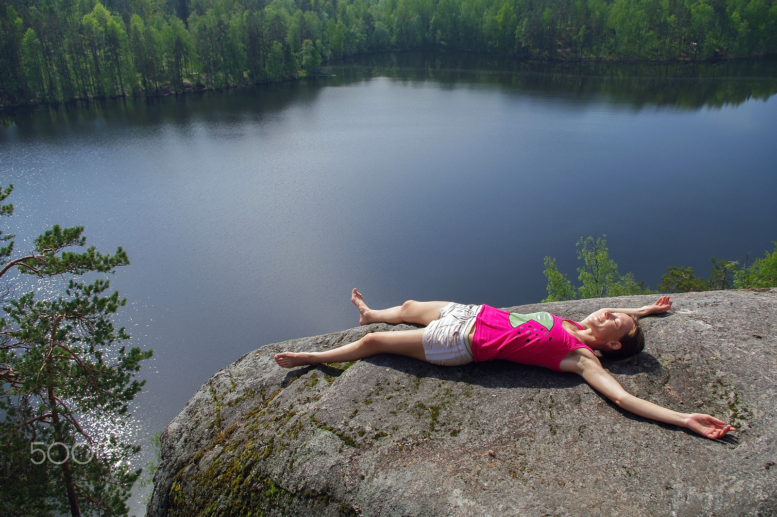 Pentax K-7 + smc PENTAX-DA L 18-55mm F3.5-5.6 sample photo. Woman laying on cliff an relaxing above the lake yastrebinoye, p photography