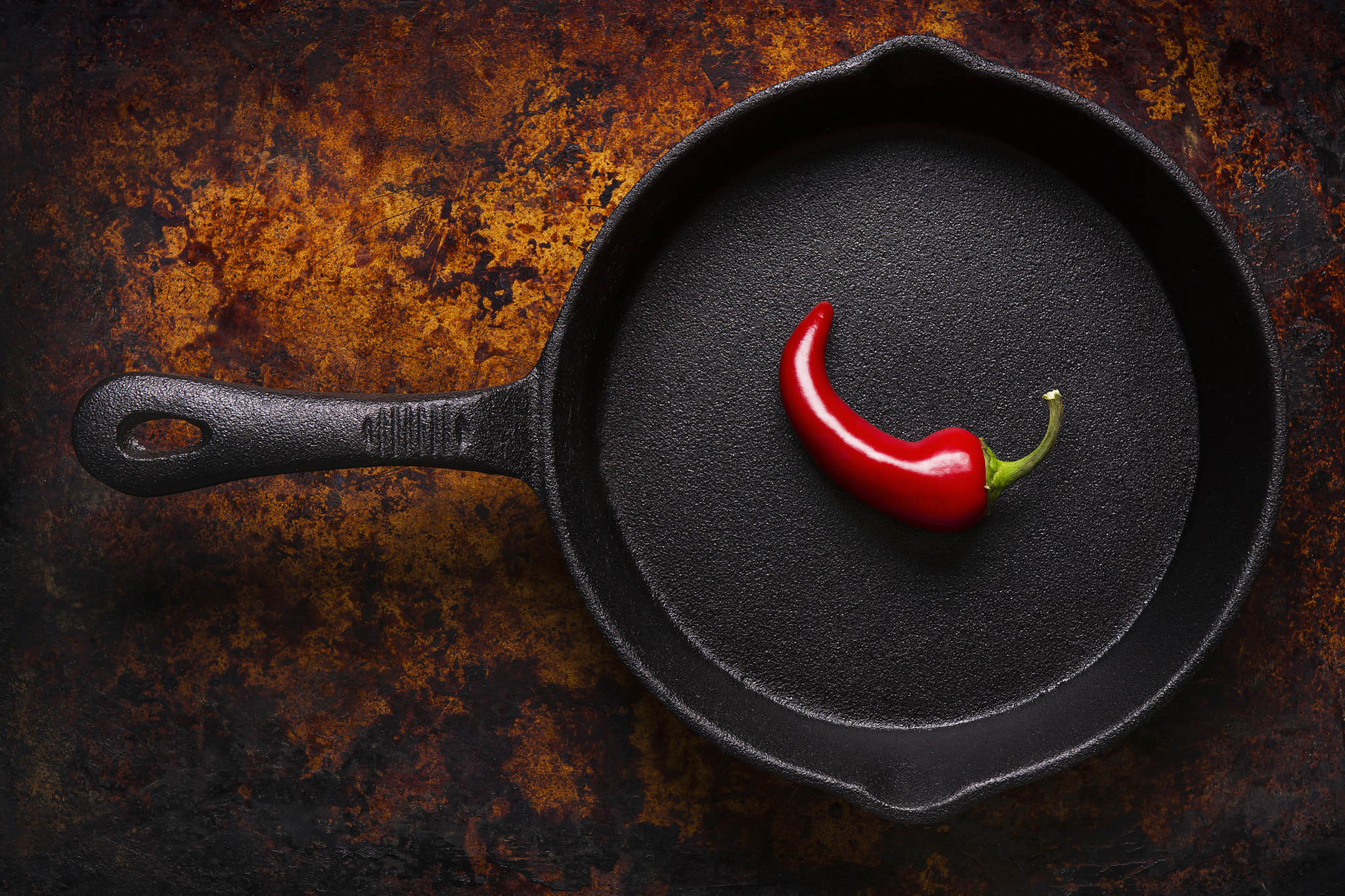Nikon D7100 + Nikon AF-S Nikkor 28-70mm F2.8 ED-IF sample photo. Red chili pepper in a black iron frying pan photography