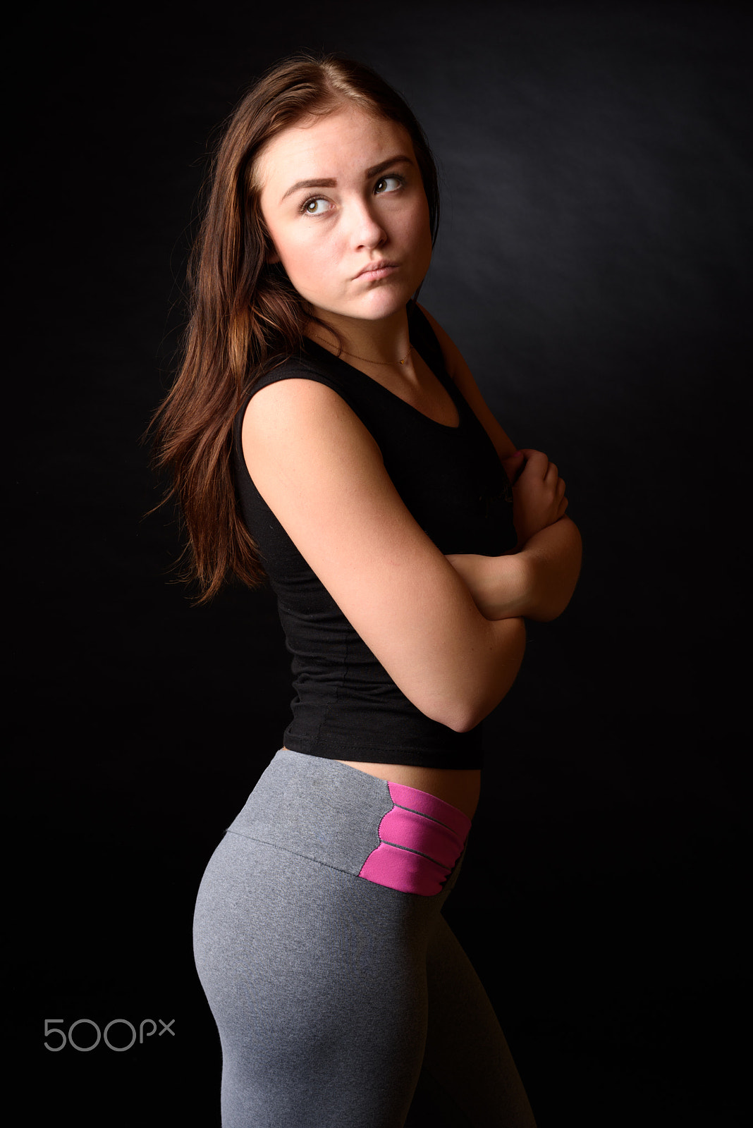 Nikon D810 + Nikon AF-S Nikkor 58mm F1.4G sample photo. Beautiful girl wearing black and grey fitness outfit isolated on black background photography