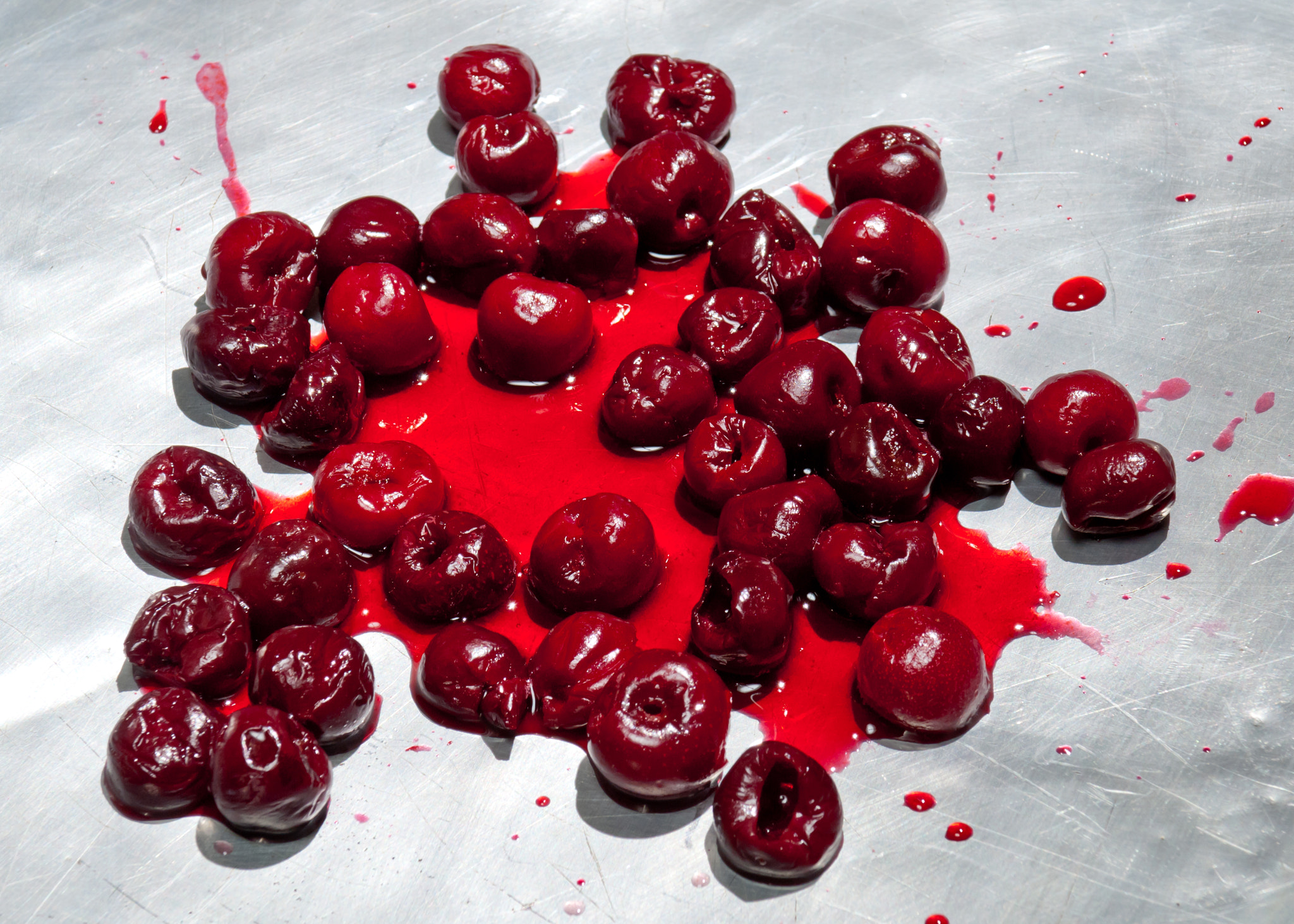 Nikon D2X sample photo. Splashed sour cherries on metallic surface sour cherry fruits photography