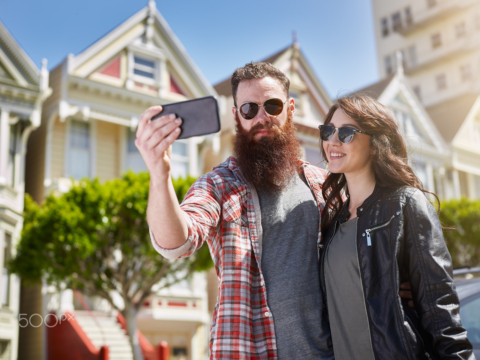 Phase One P65+ sample photo. Couple taking selfie in front of painted ladies in photography