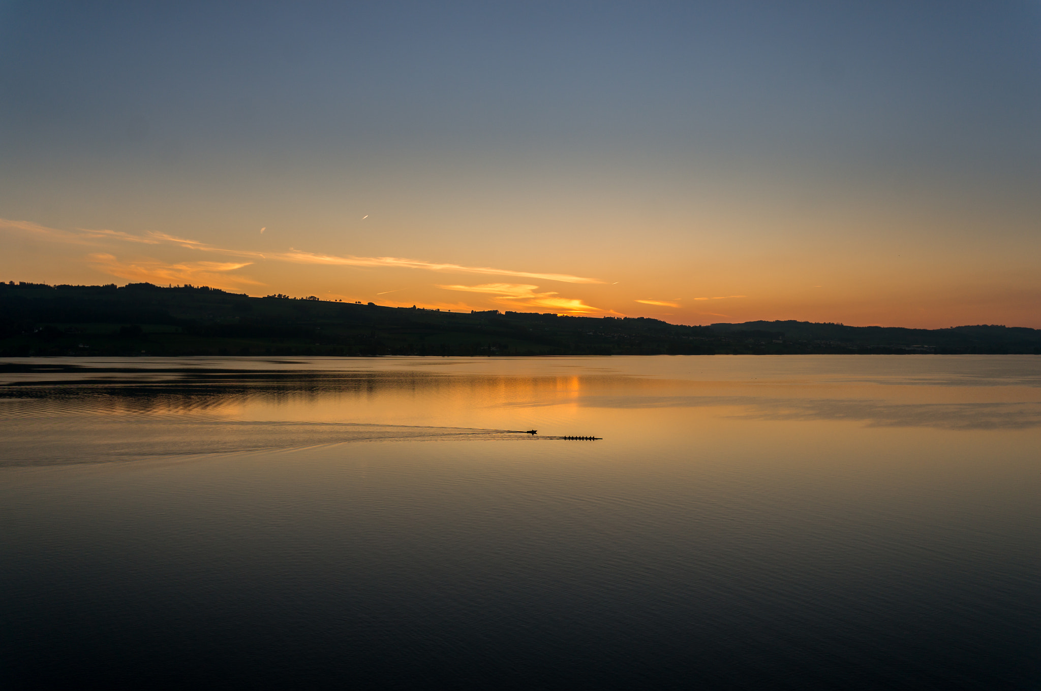 Sony Alpha NEX-5T + Sony E 16mm F2.8 sample photo. Paddling across the sunset photography