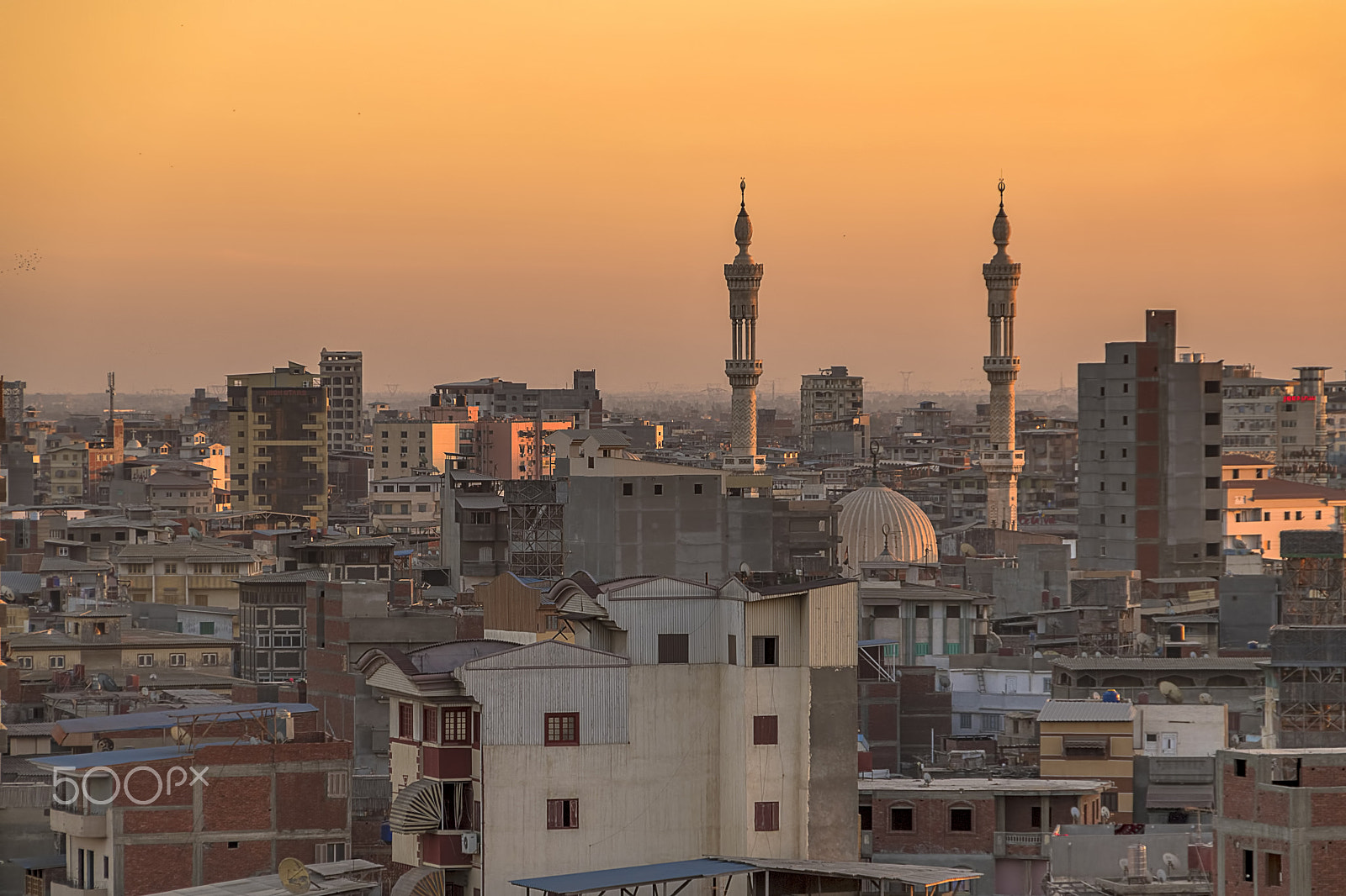 Nikon D5500 + Sigma 18-250mm F3.5-6.3 DC OS HSM sample photo. Minaret between buildings skyline of majestic city photography