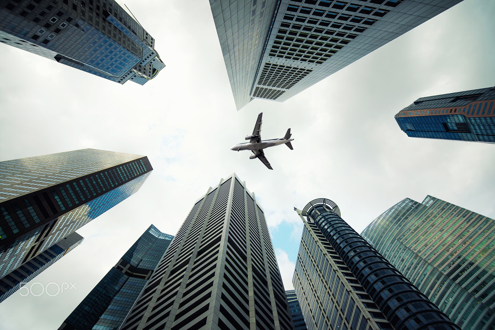 Nikon D800 sample photo. Singapore city buildings and a plane flying overhead in morning photography
