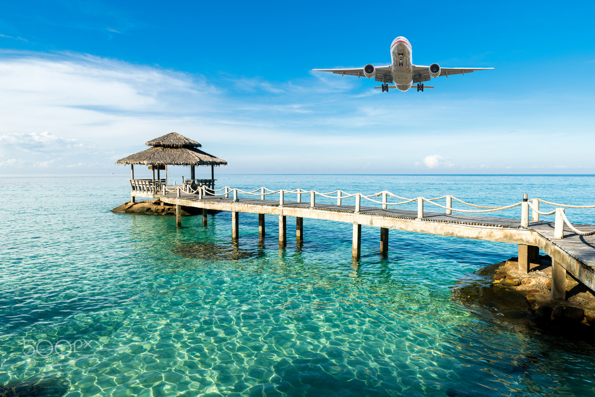 Airplane is arriving tropical resort in the morning.