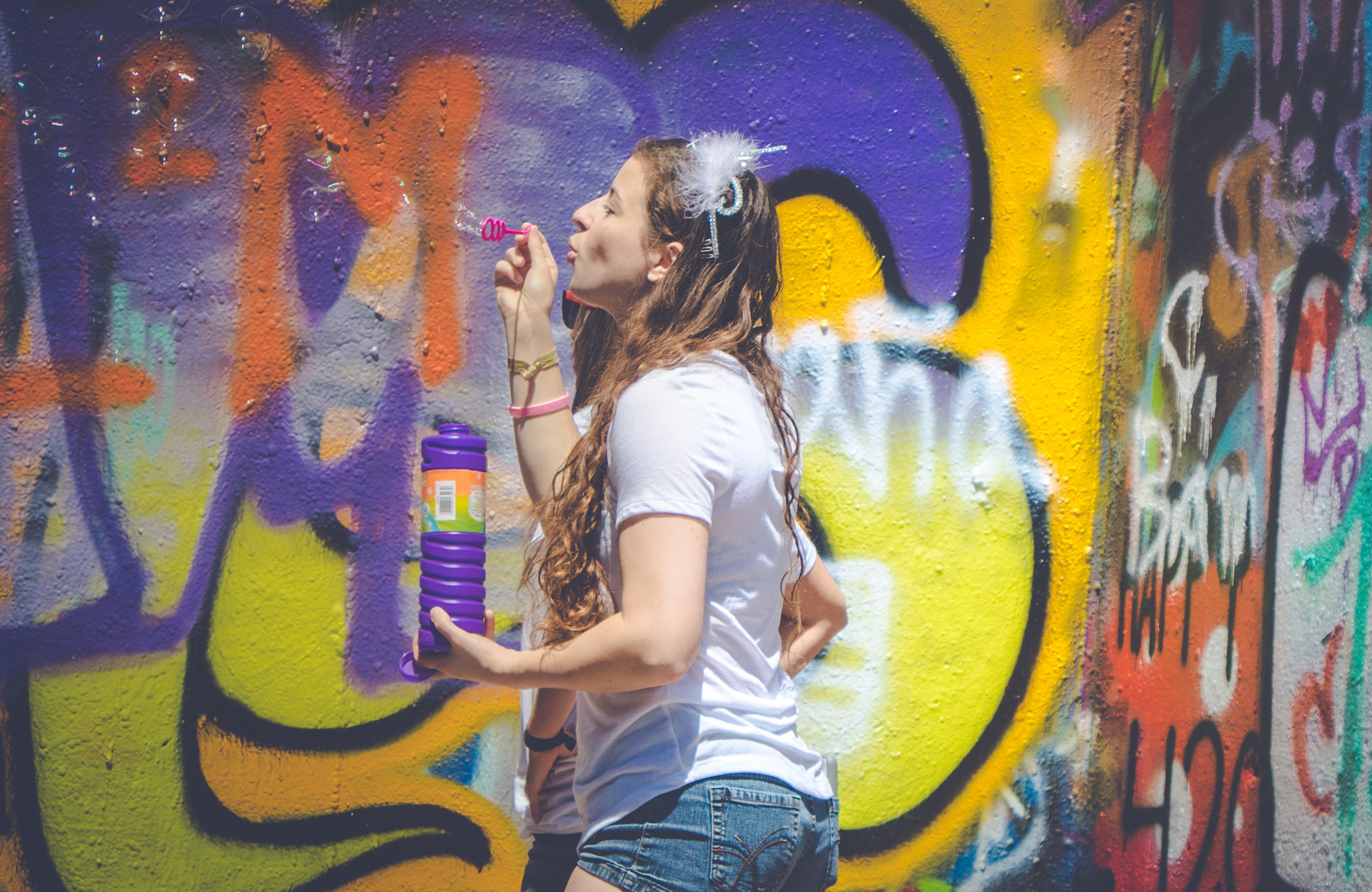Sony ILCA-77M2 + Tamron SP 24-70mm F2.8 Di VC USD sample photo. Girl blowing bubbles at graffiti park photography