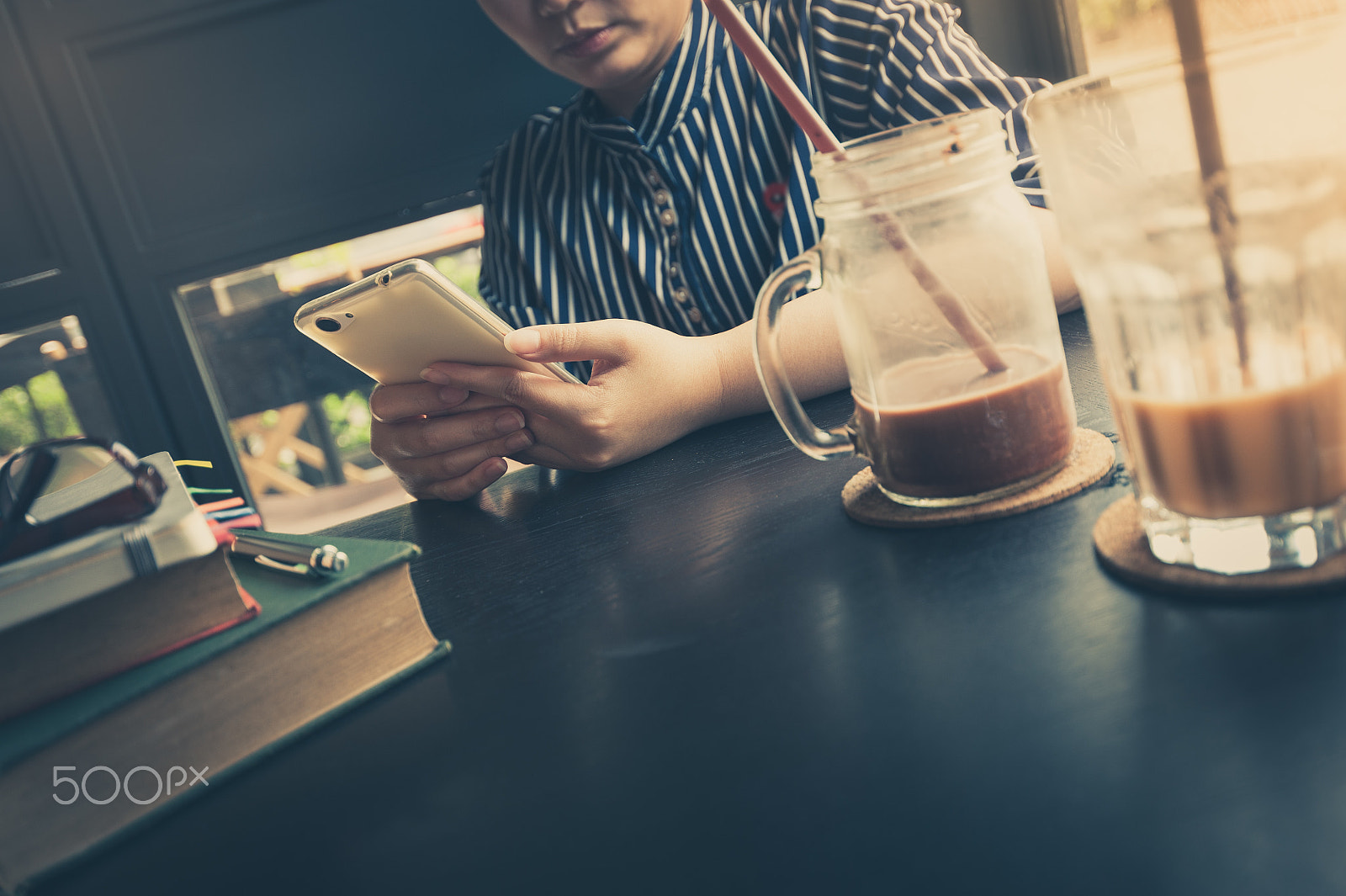 Nikon AF-S Nikkor 18-35mm F3.5-4.5G ED sample photo. Woman using phone in cafe photography
