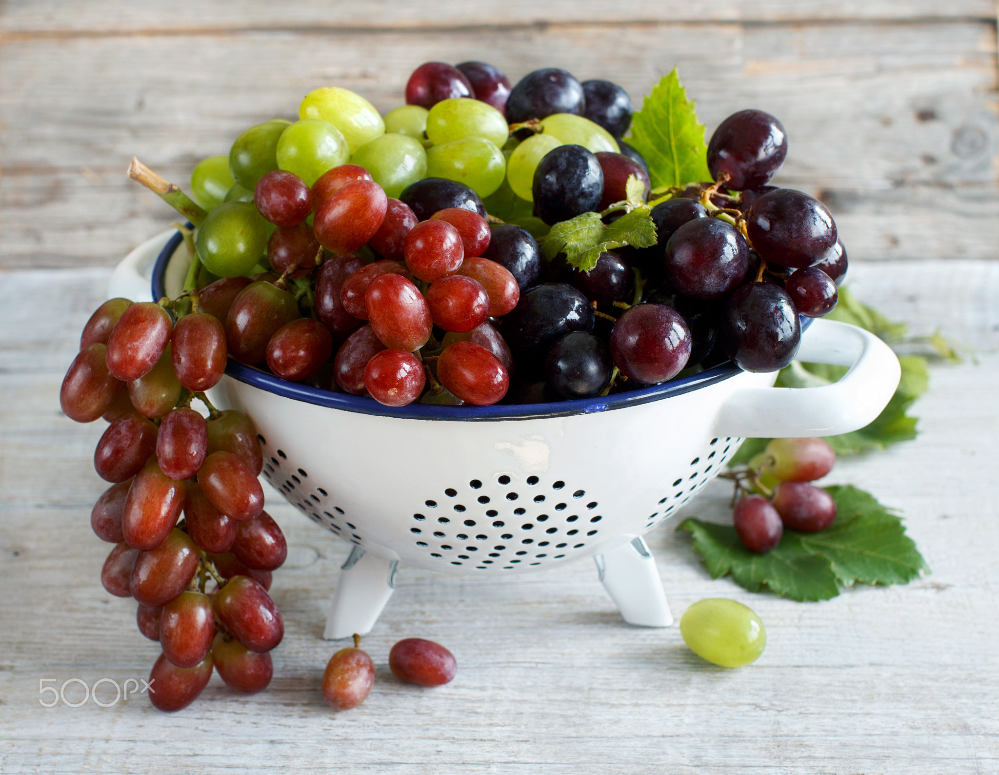 White, red and blue grapes  in a bowl