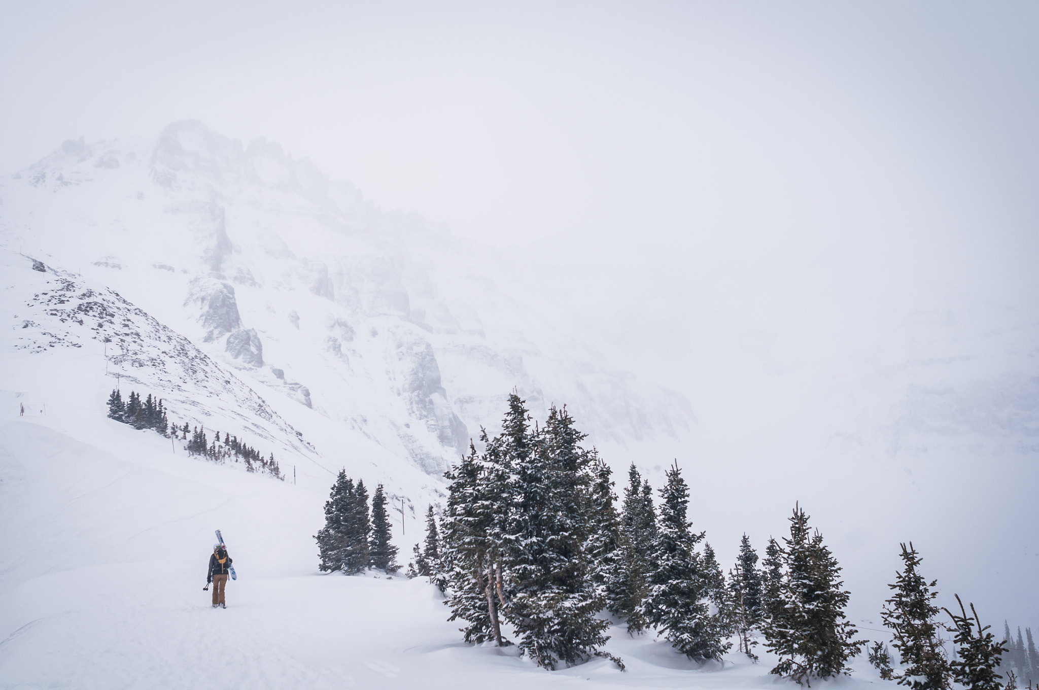 Nikon D300 + AF Nikkor 24mm f/2.8 sample photo. A woman hikes with skis in the winter time photography