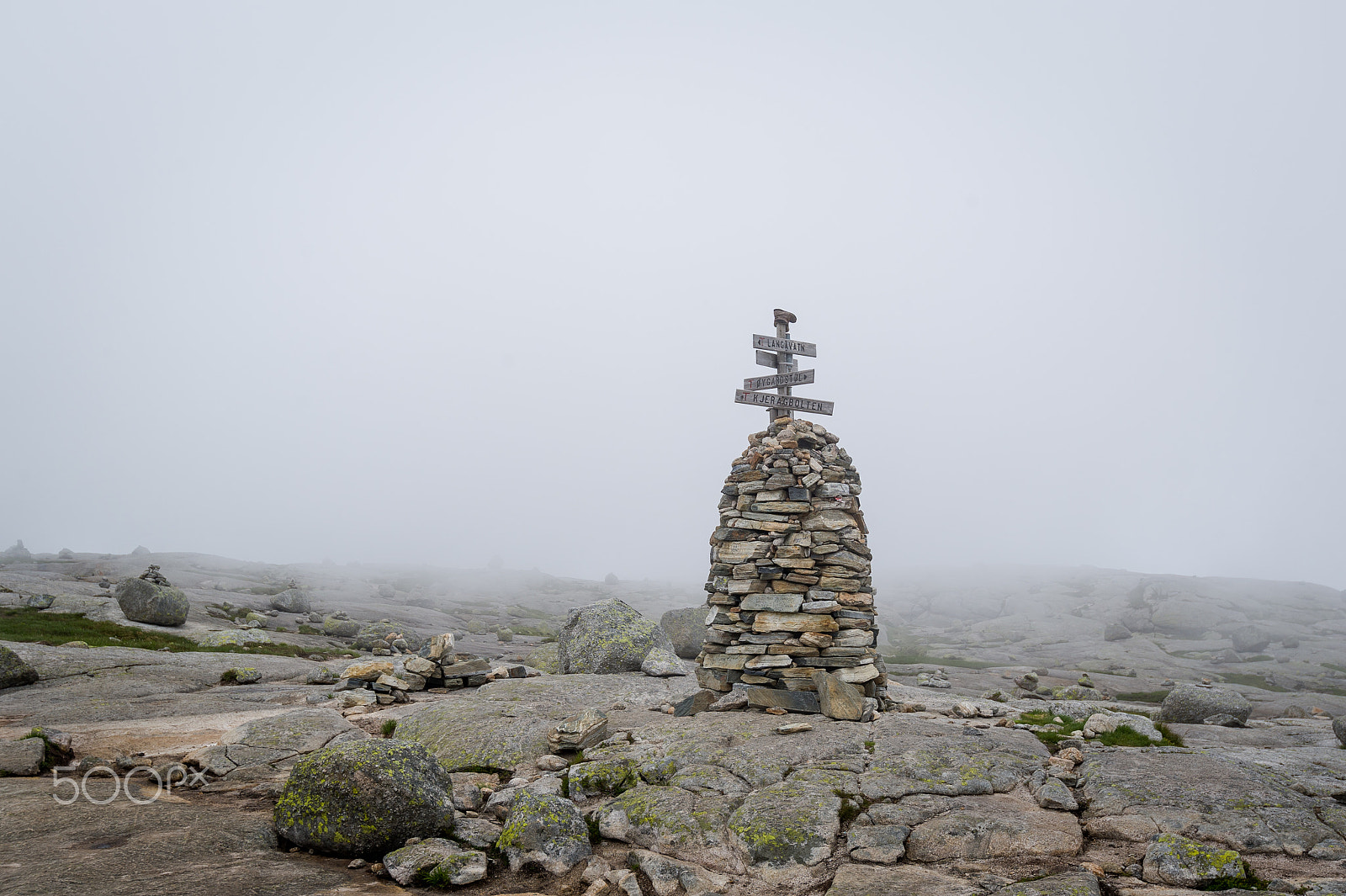 Nikon D3S + Nikon AF-S Nikkor 16-35mm F4G ED VR sample photo. Stone pyramide with hiking path route sign in the foggy weather. photography