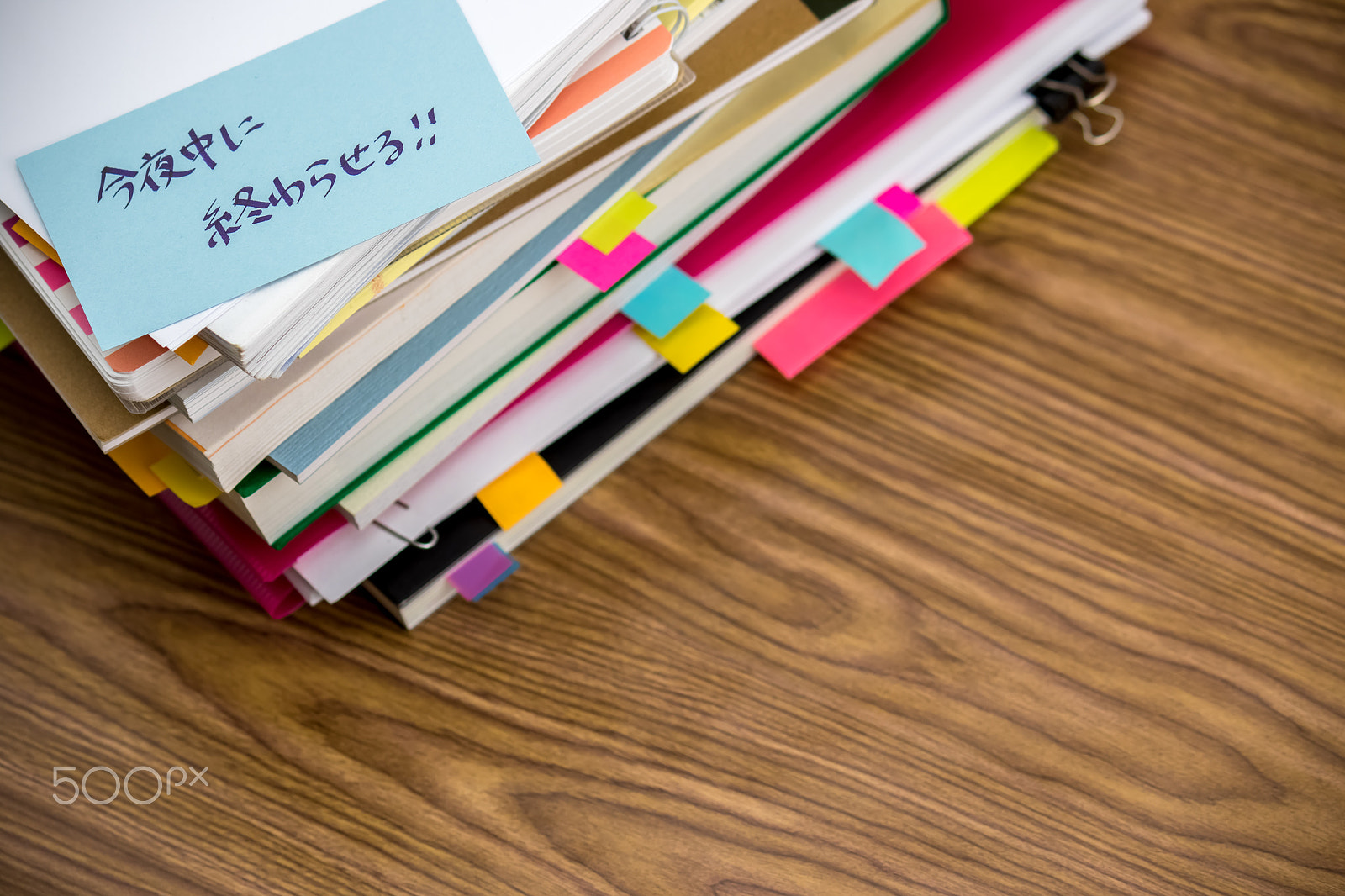 Canon EF-S 55-250mm F4-5.6 IS sample photo. Finish tonight; the pile of business documents on the desk photography