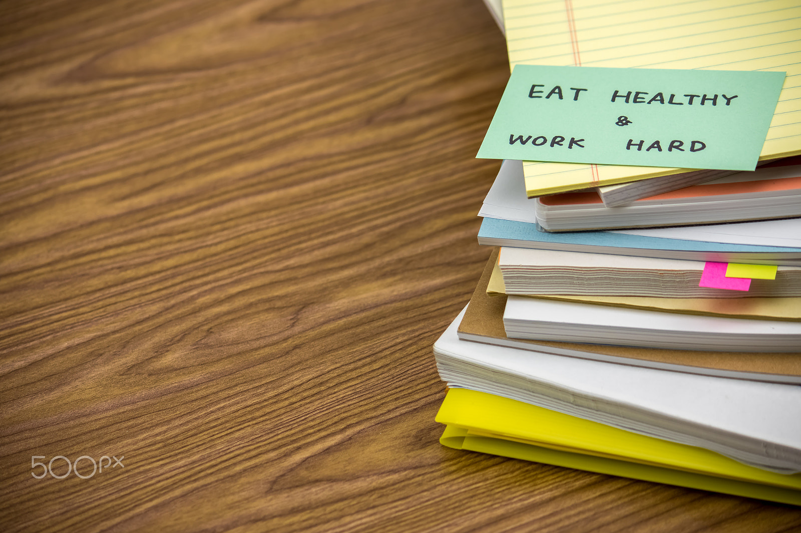 Canon EF-S 55-250mm F4-5.6 IS sample photo. Eat healthy work hard; the pile of business documents on the des photography